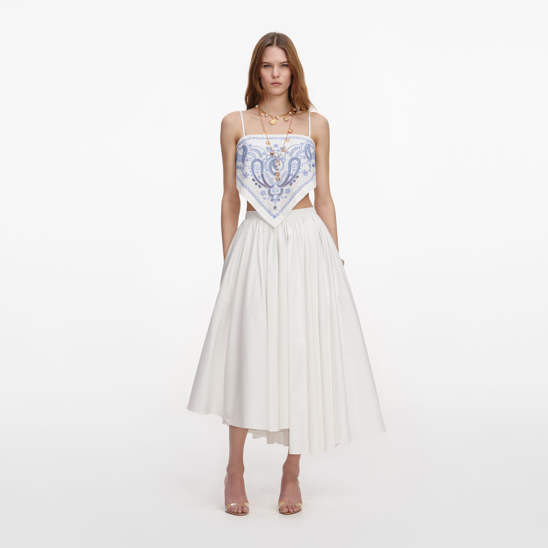 Front view of a woman wearing the White And Blue Embroidered Linen Top