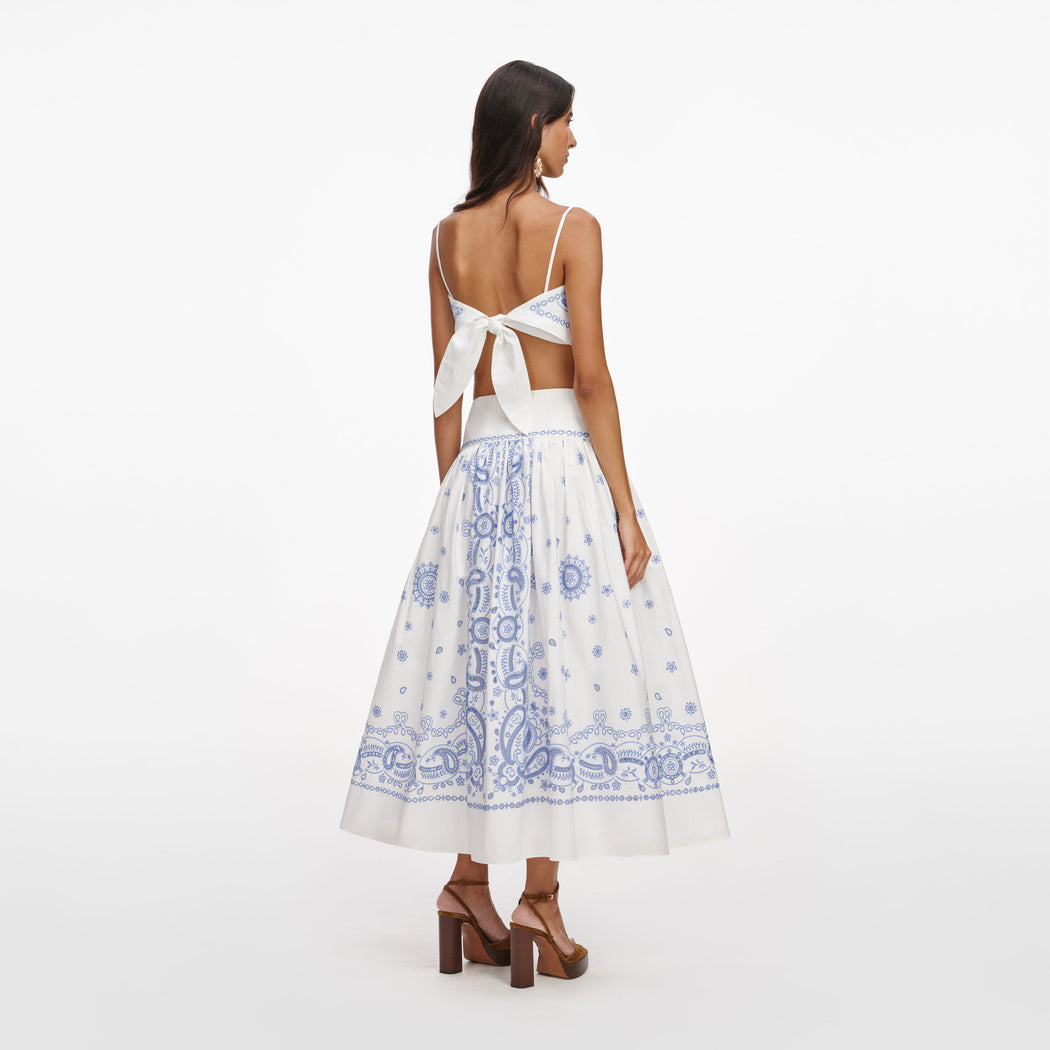 Back view of a woman wearing the White And Blue Embroidered Midi Skirt