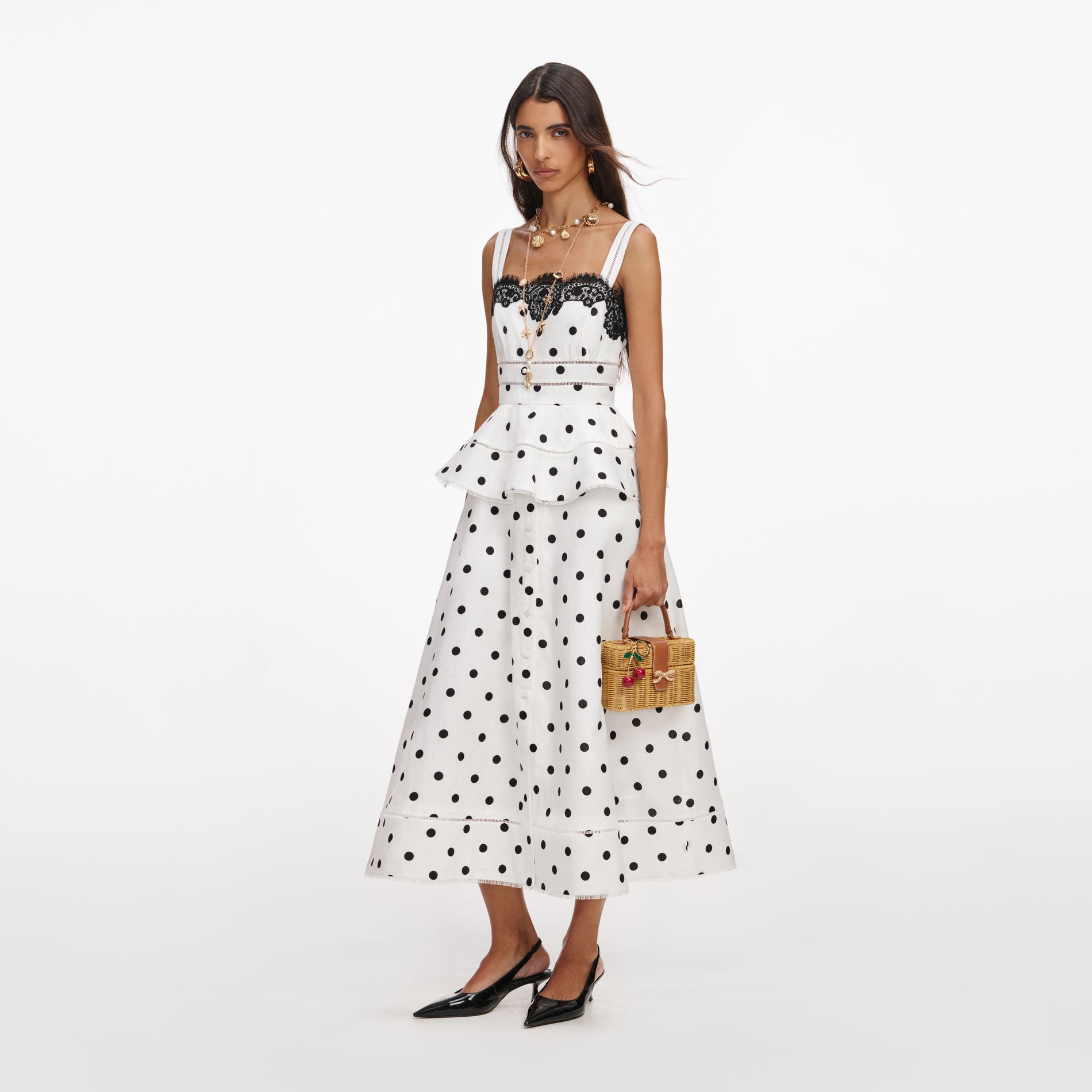 Side view of a woman wearing the White Polka Dot Linen Midi Dress