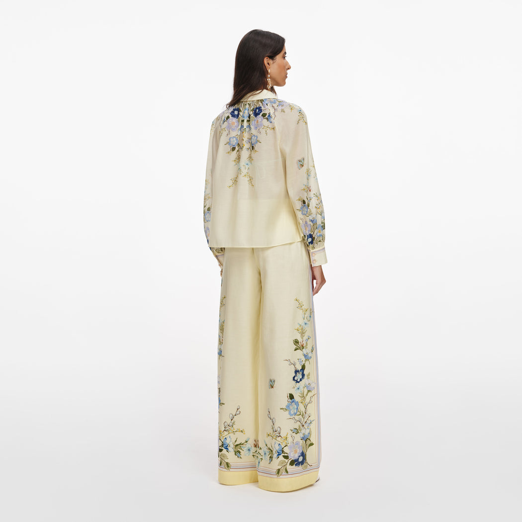 Back view of a woman wearing the Yellow Floral Organza Trousers