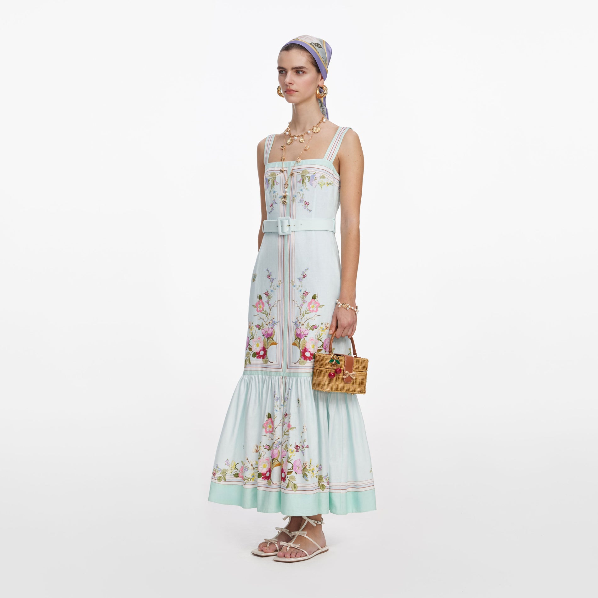 Side view of a woman wearing the Mint Floral Linen Midi Dress