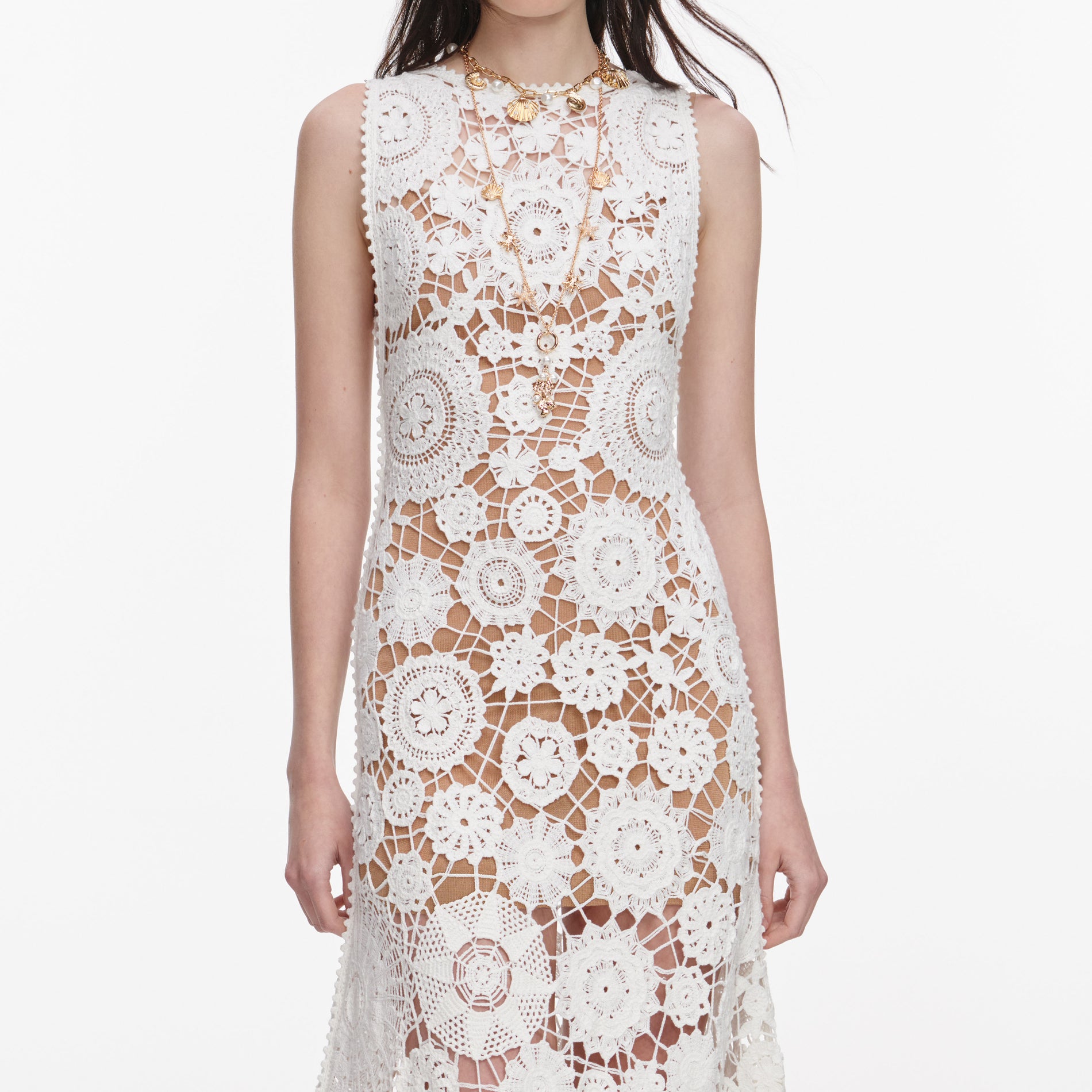 A close up of a woman wearing the White Crochet Maxi Dress