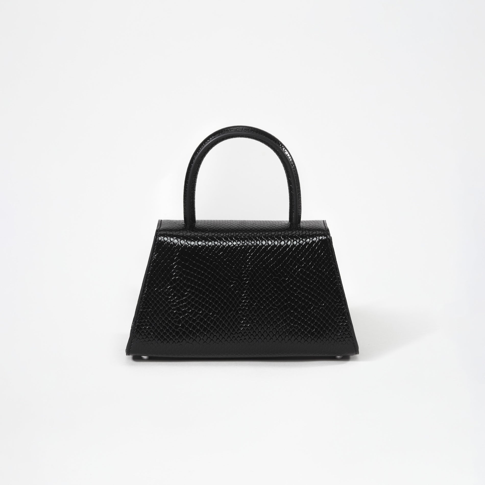 A woman wearing the Black Python Diamante Bow Mini Bag