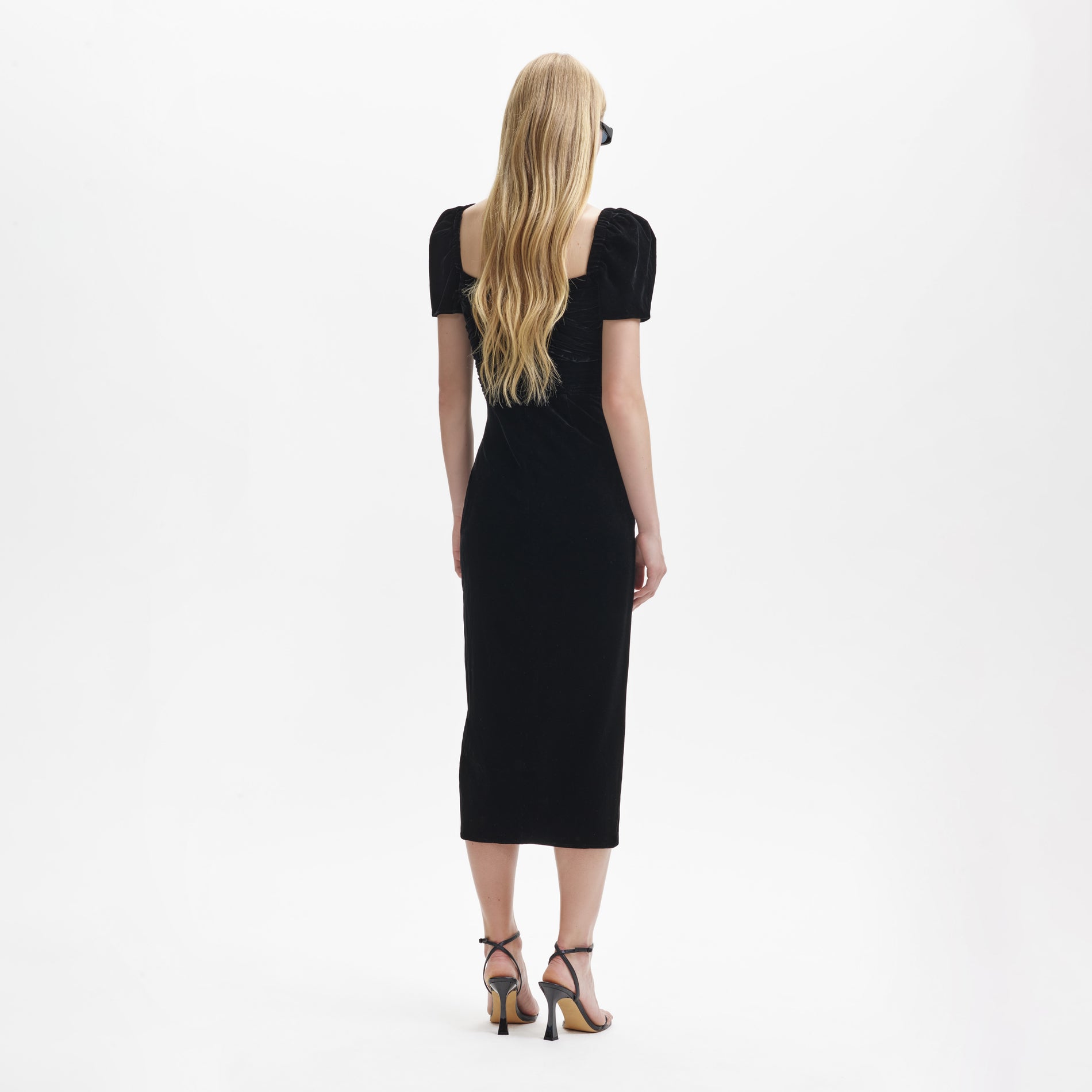 Back view of a woman wearing the Black Velvet Iris Midi Dress