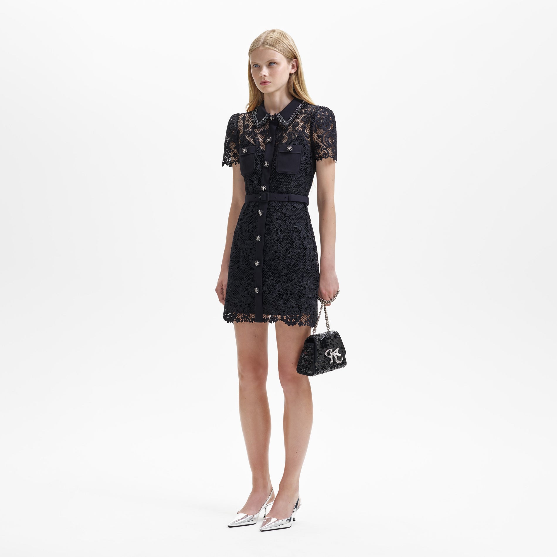 A woman wearing the Black Lace Button Front Mini Dress