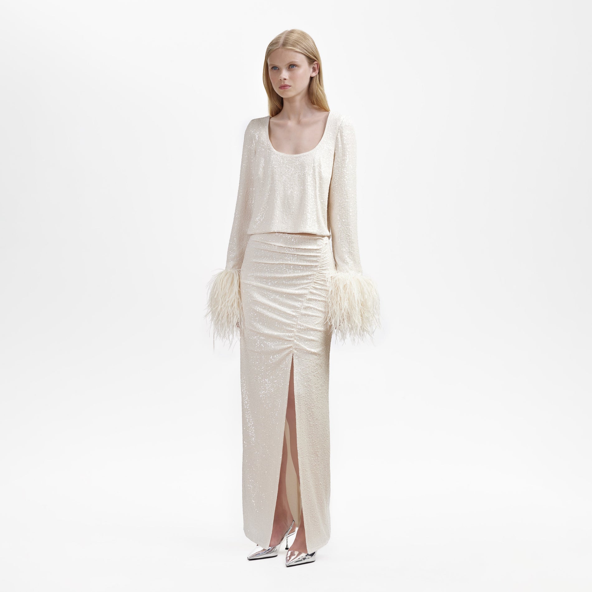 A woman wearing the Cream Sequin Maxi Skirt