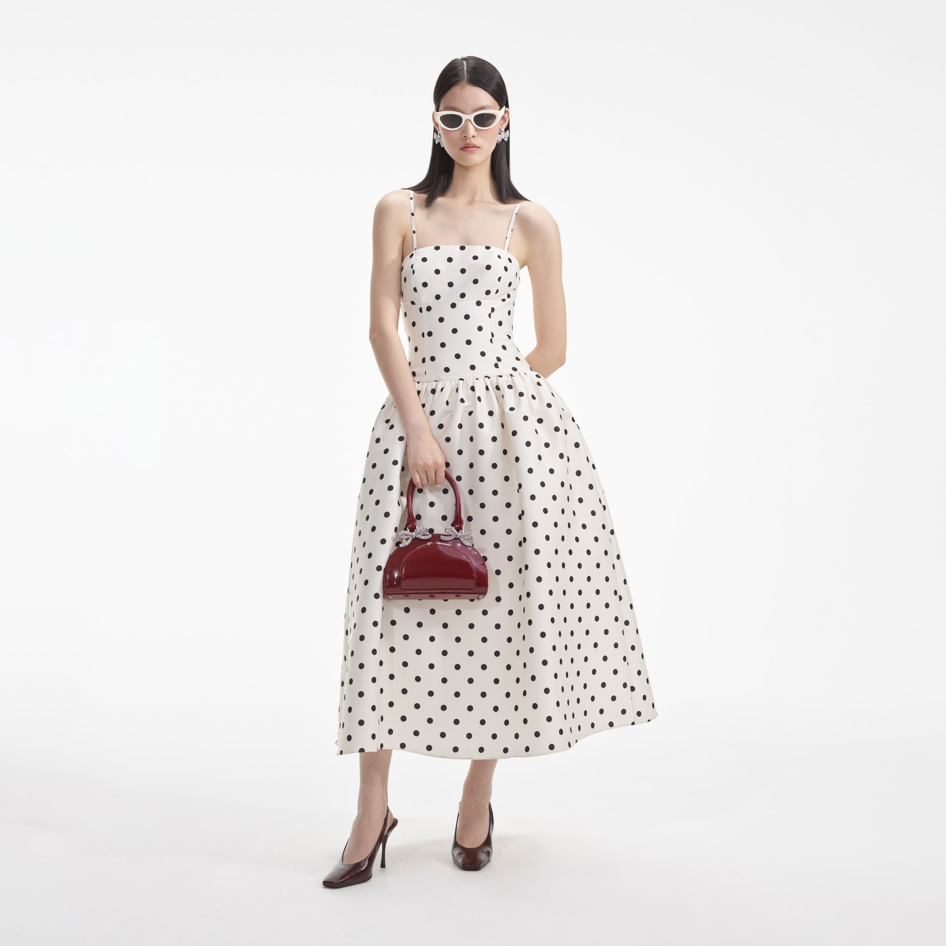 Side view of a woman wearing the Cream Polka Dot Taffeta Midi Dress
