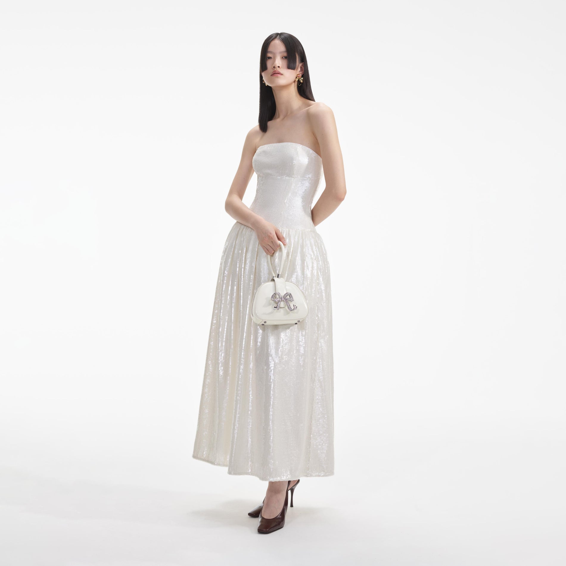 Side view of a woman wearing the Cream Sequin Bandeau Midi Dress