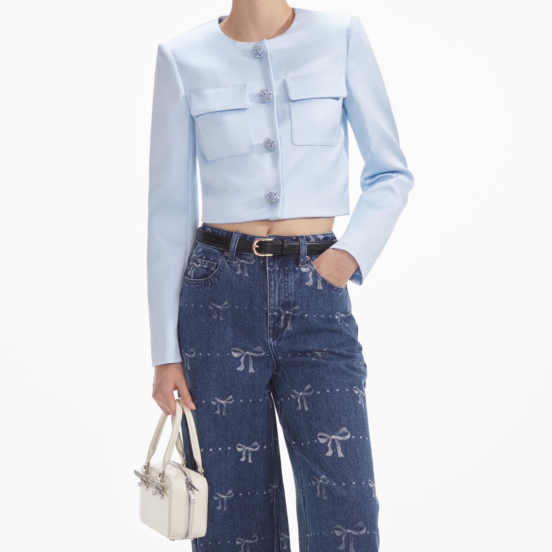 A close up of a woman wearing the Bow Print Jeans