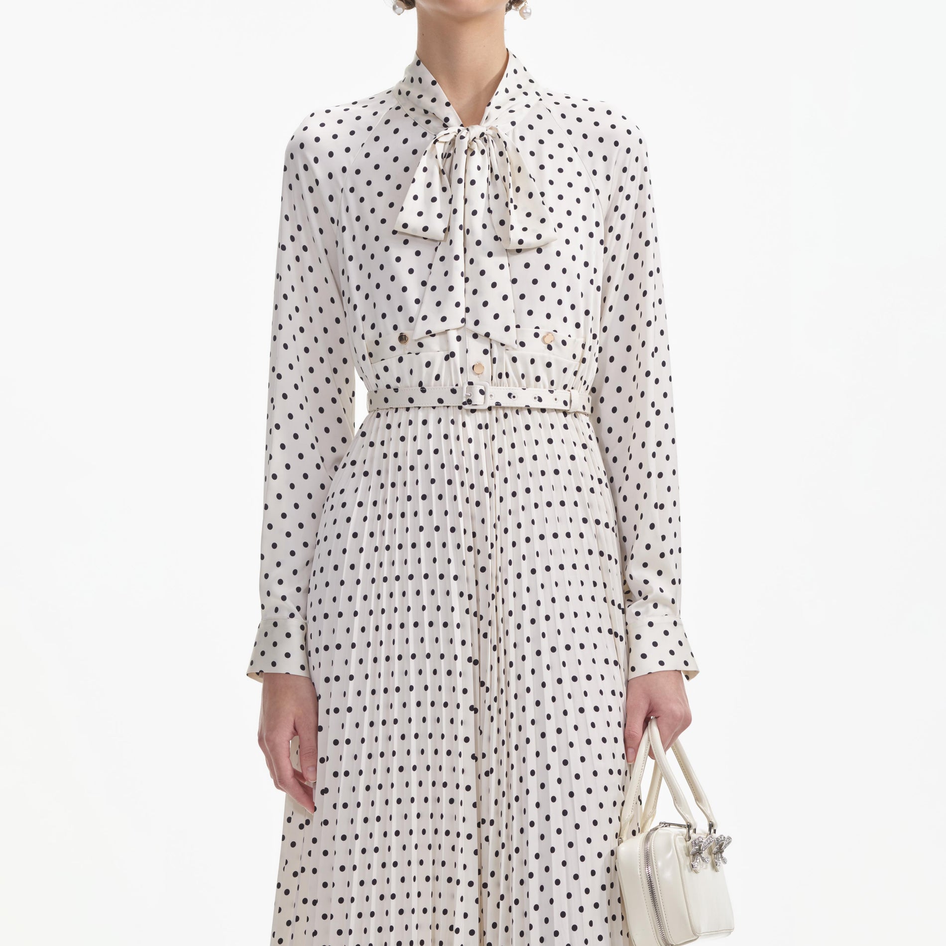 A close up of a woman wearing the Cream Polka Dot Satin Midi Dress