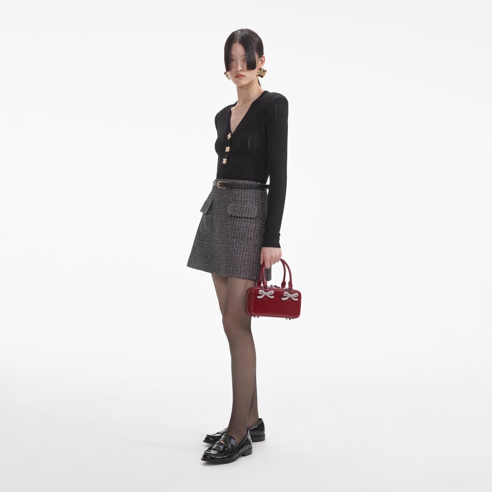 Side view of a woman wearing the Black Pointelle Knit Top