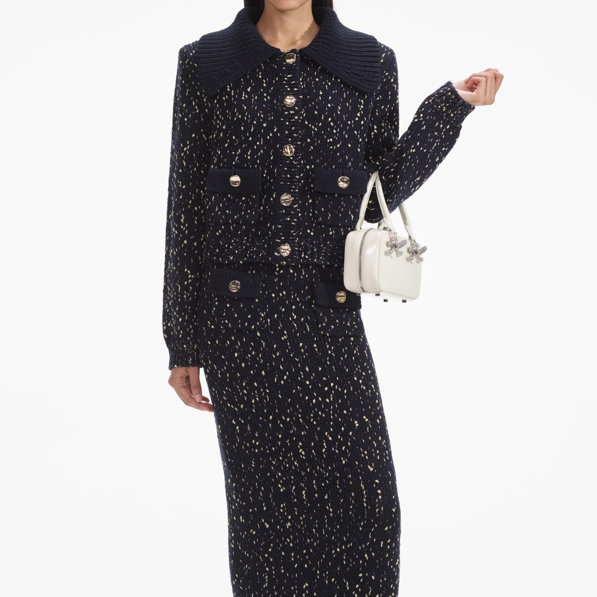 A close up of a woman wearing the Navy Metallic Merino Knit Midi Skirt