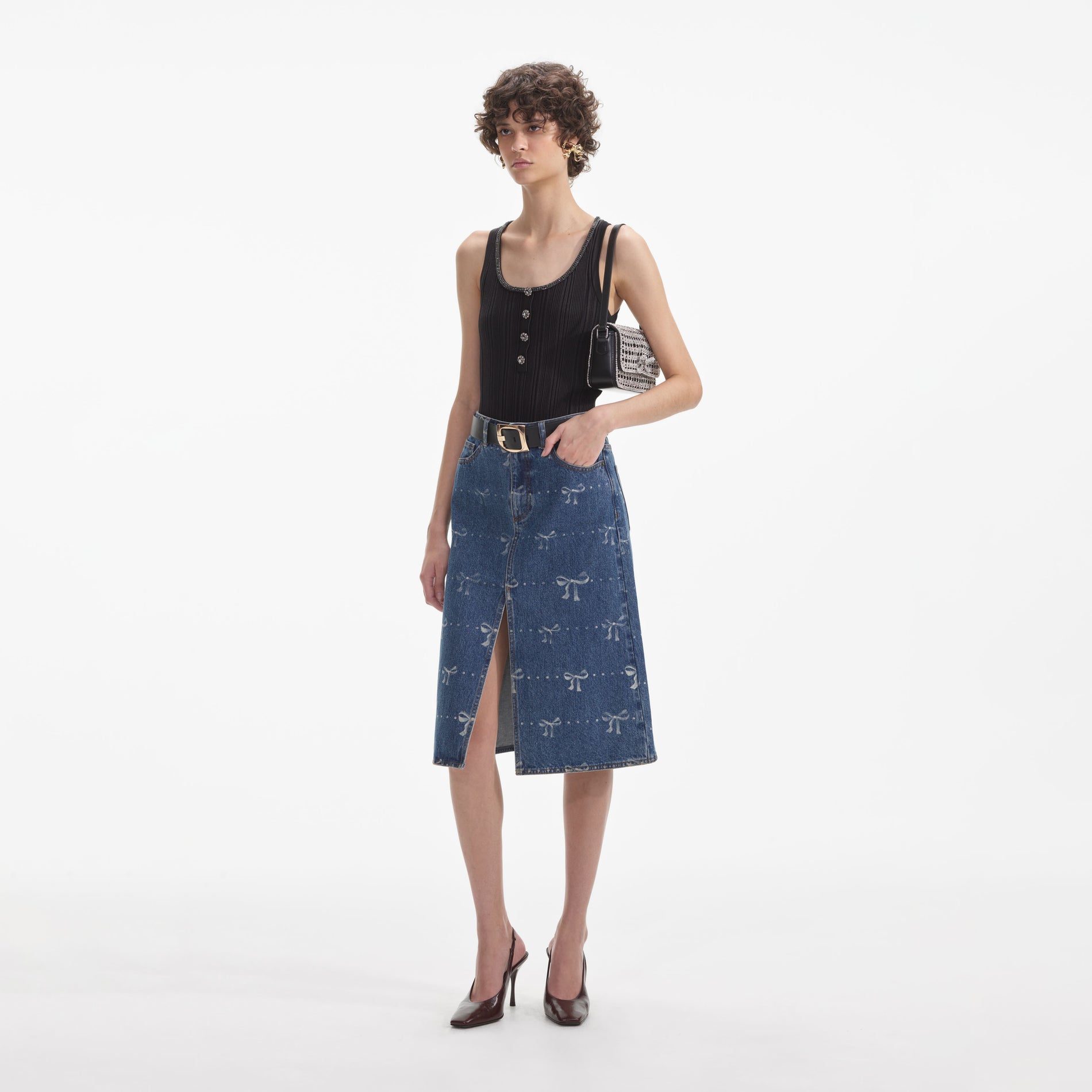 Side view of a woman wearing the Bow Print Denim Midi Skirt