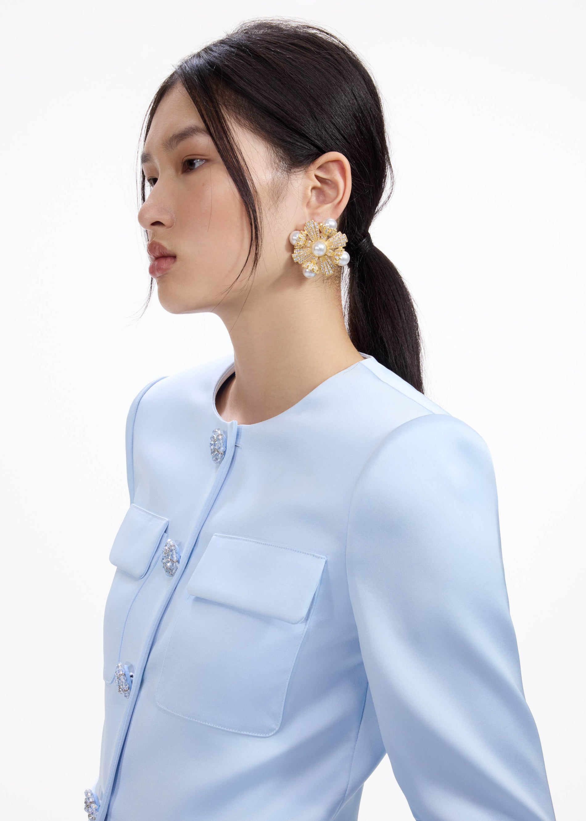 A close up of a woman wearing the Large Gold Encrusted Earrings