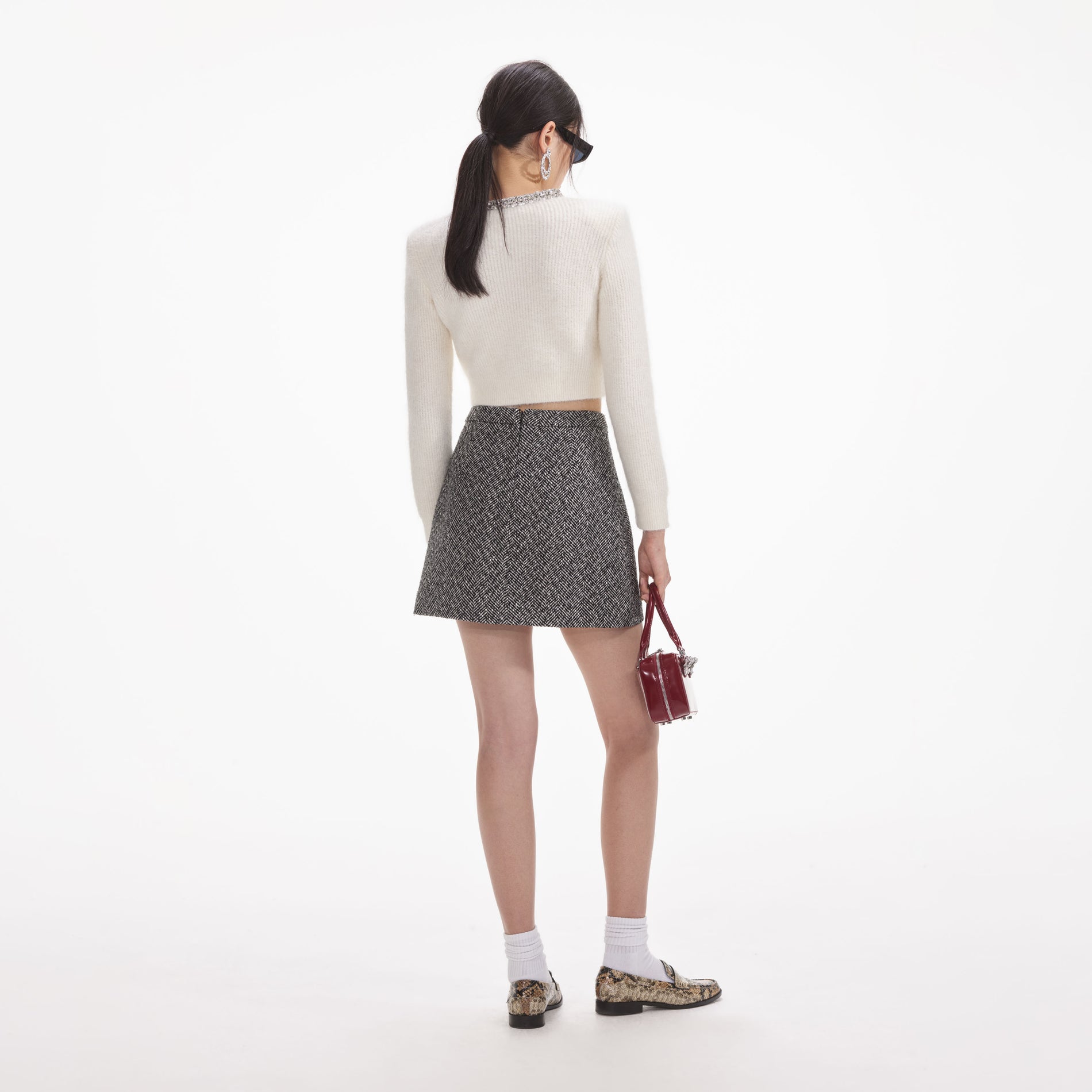 Back view of a woman wearing the White Cream Soft Knit Cardigan