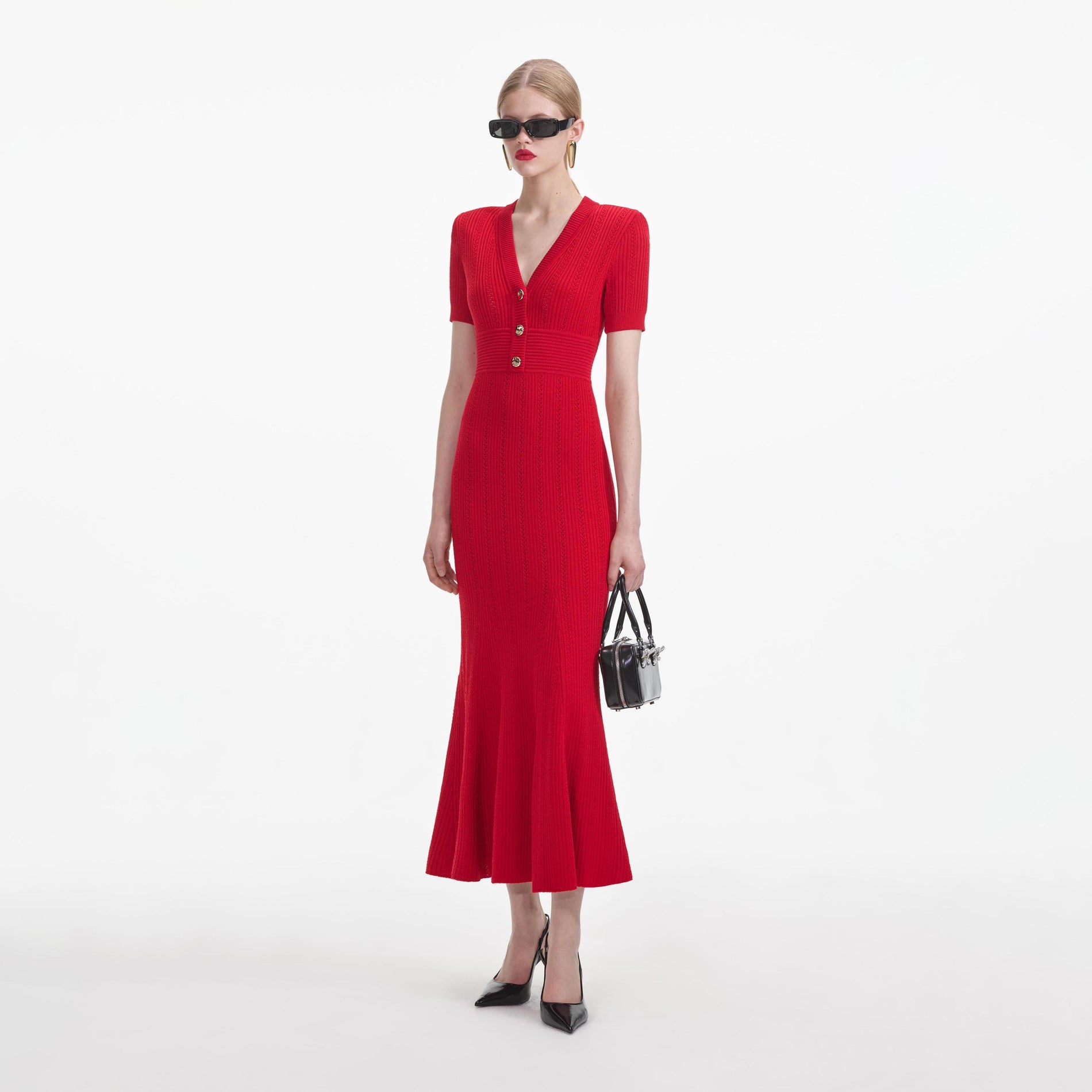 Side view of a woman wearing the Red Pointelle Knit Midi Dress