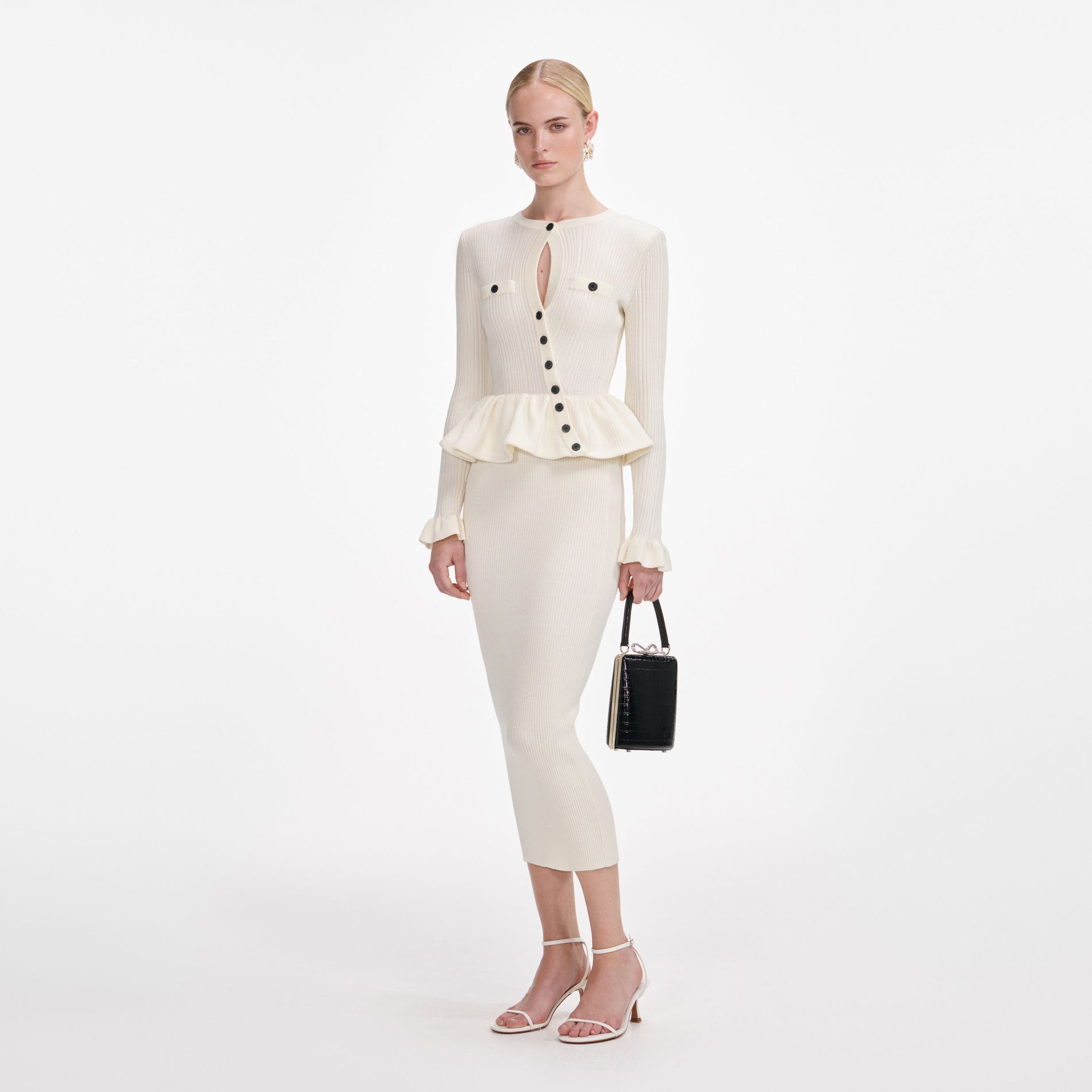 Side view of a woman wearing the Cream Asymmetric Knit Midi Dress