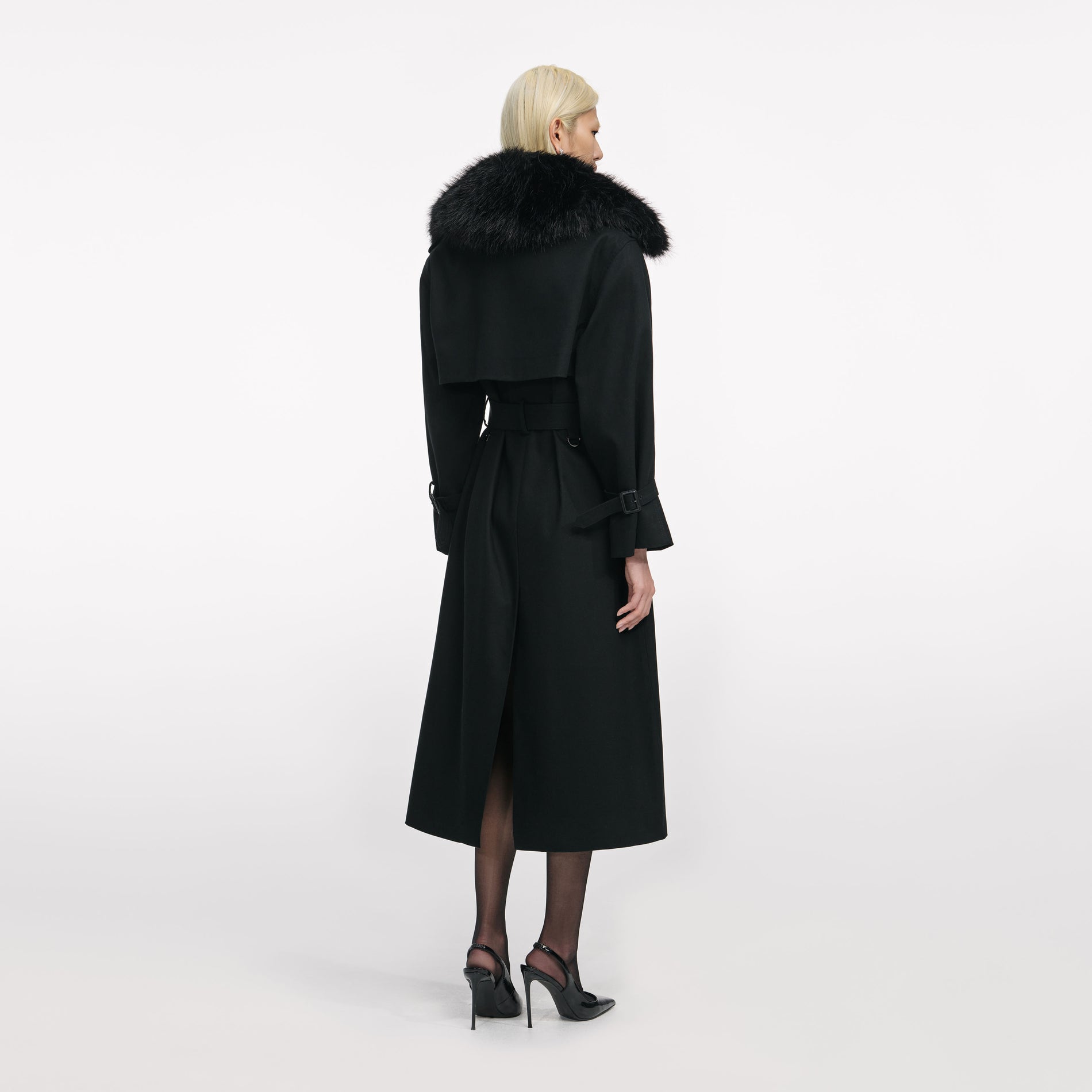 Back view of a woman wearing the Black Twill Fur Collar Trench Coat