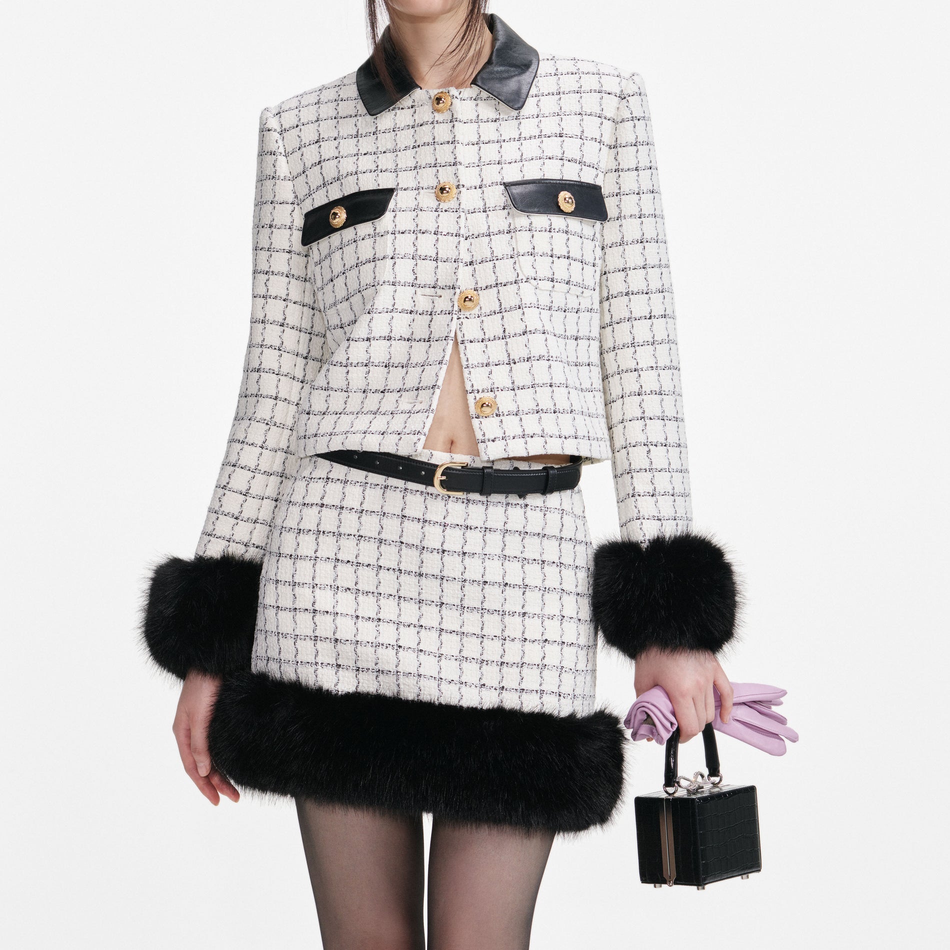 A close up of a woman wearing the Check Boucle Fur Cuff Jacket