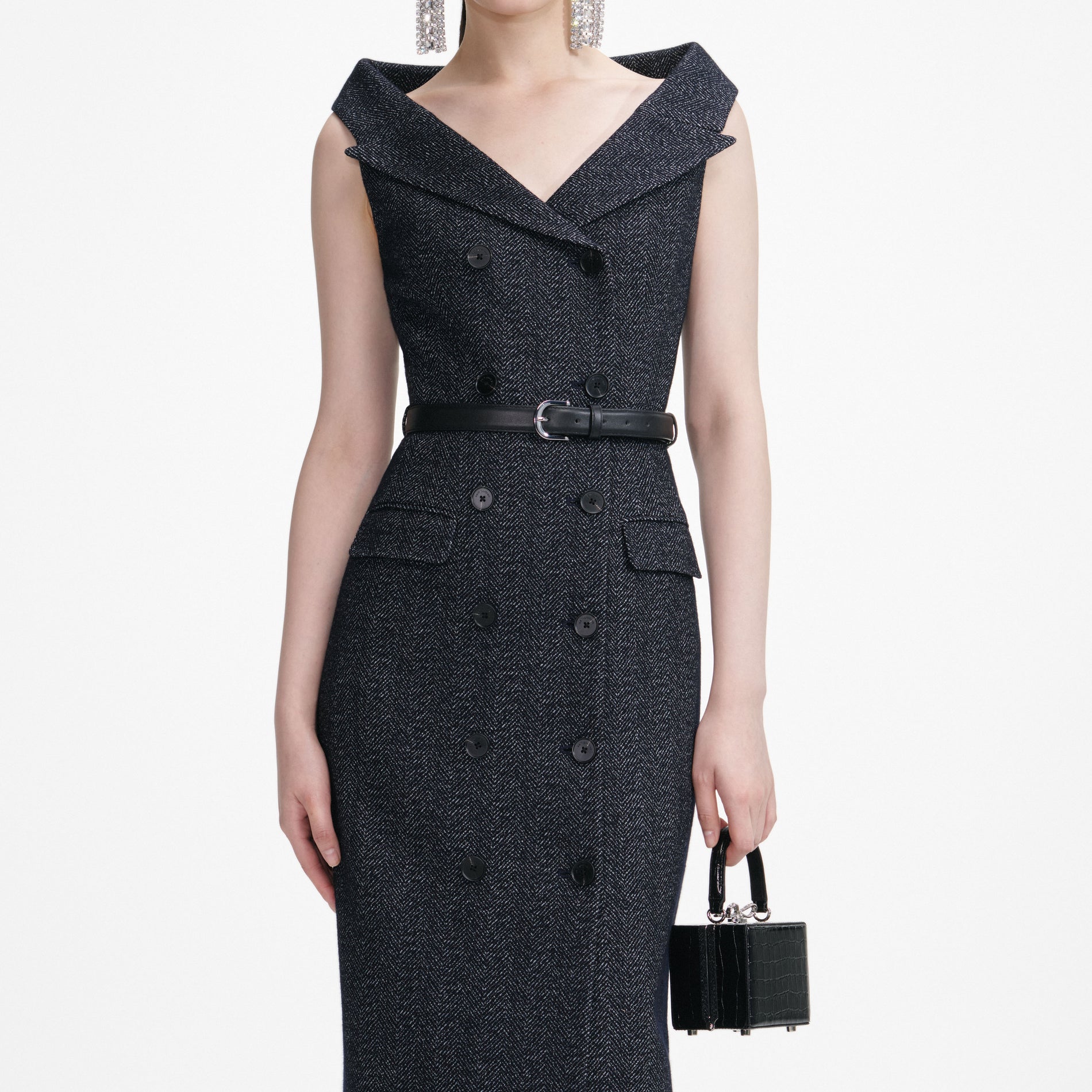 A close up of a woman wearing the Navy Herringbone Wool Midi Dress