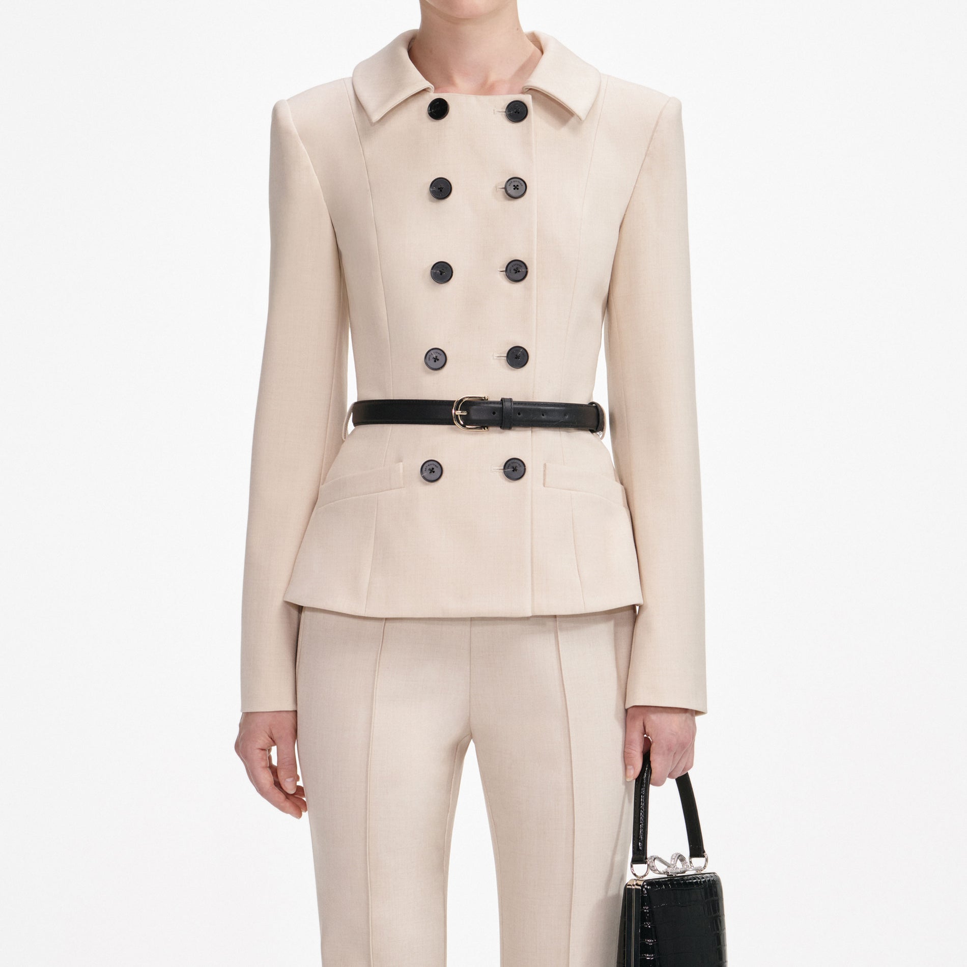 A close up of a woman wearing the Beige Twill Jumpsuit