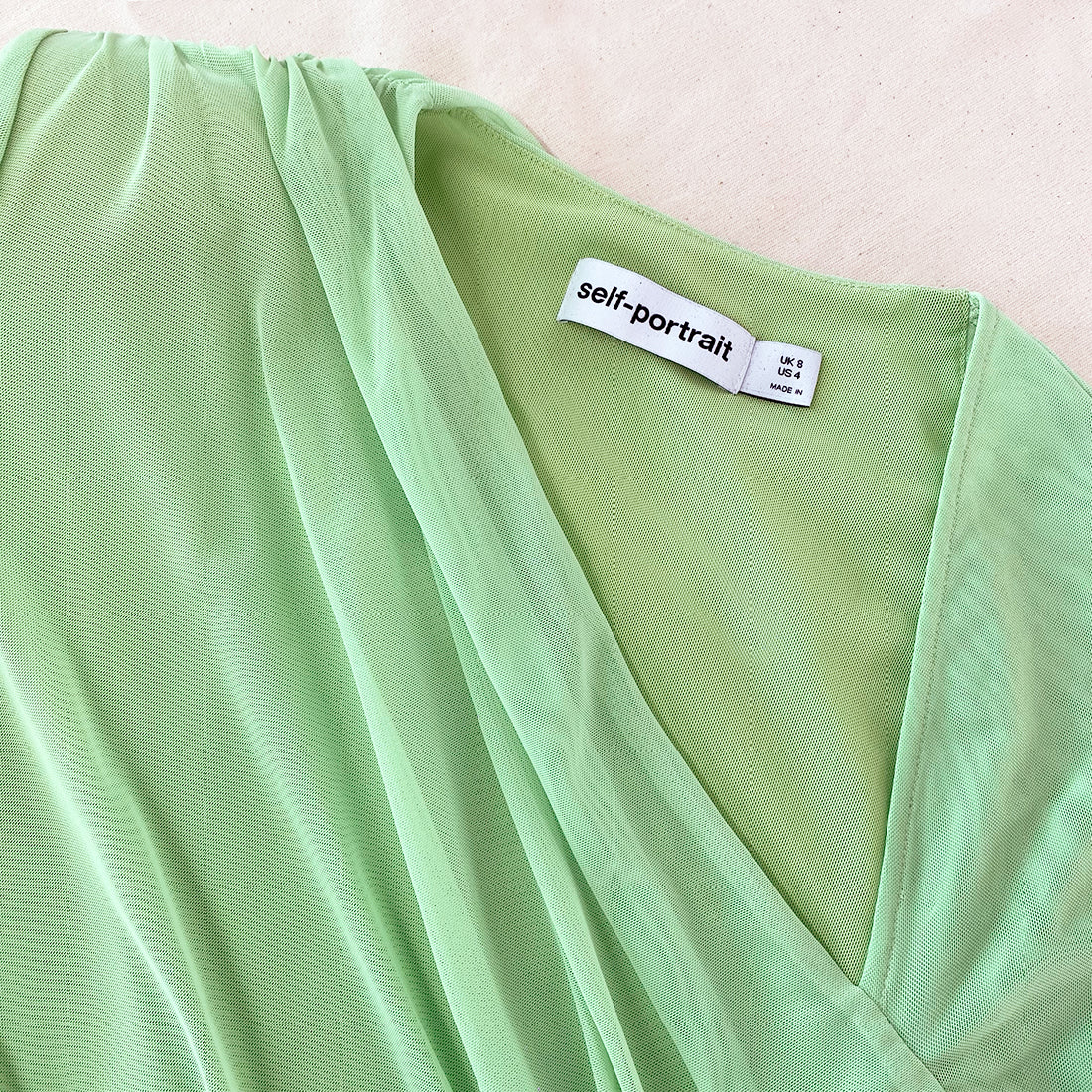 A close up of the fabric for the Green Mesh Ruched Midi Dress