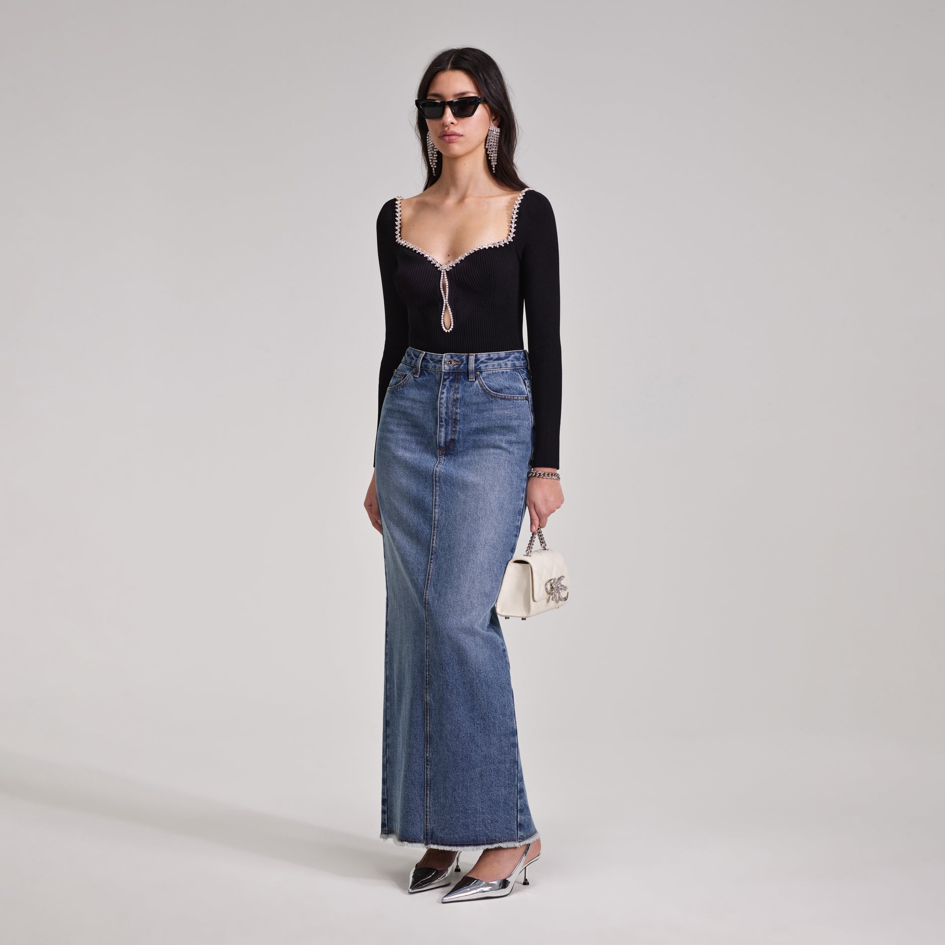 A woman wearing the Black Knit Diamante Top