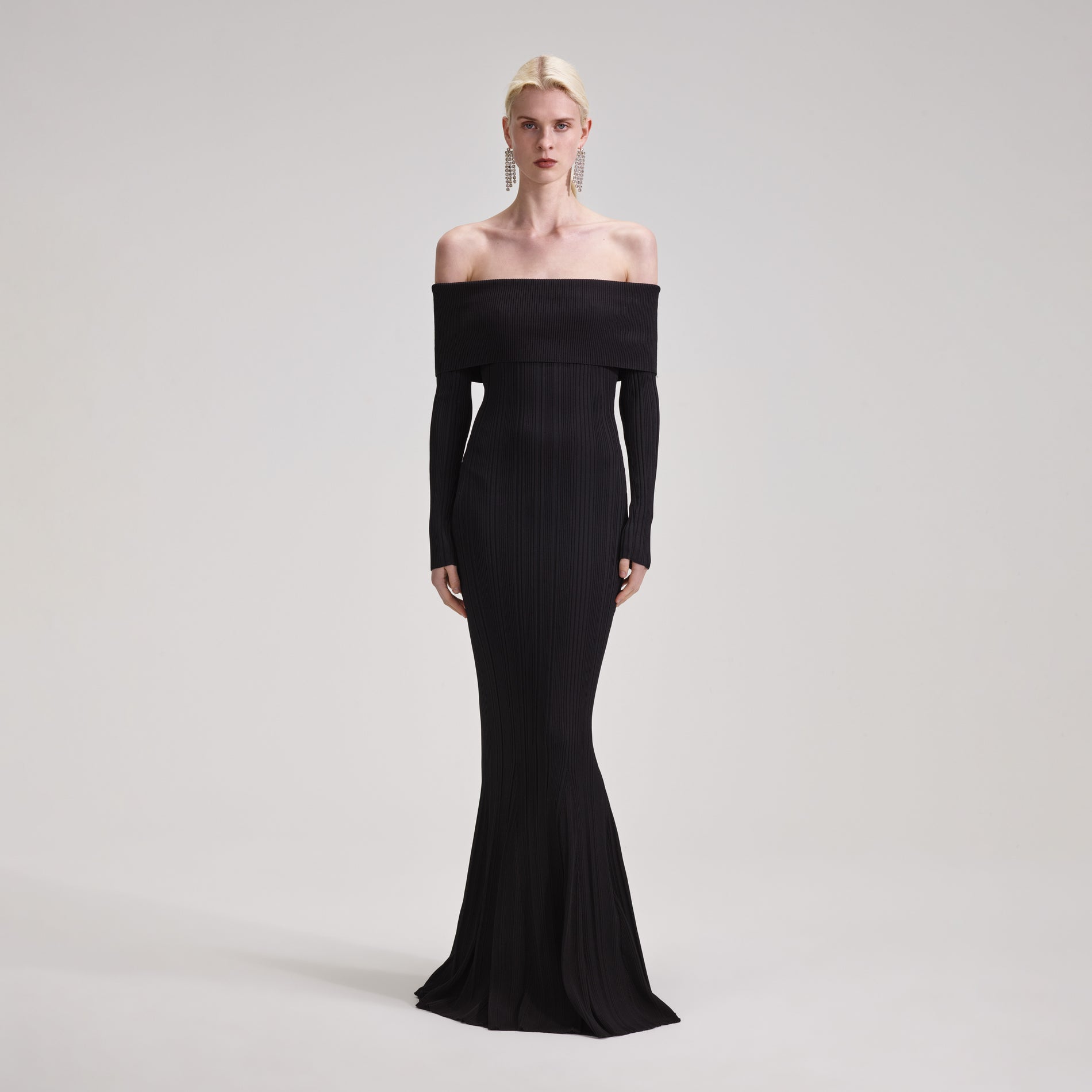 A woman wearing the Black Ribbed Knit Maxi Dress