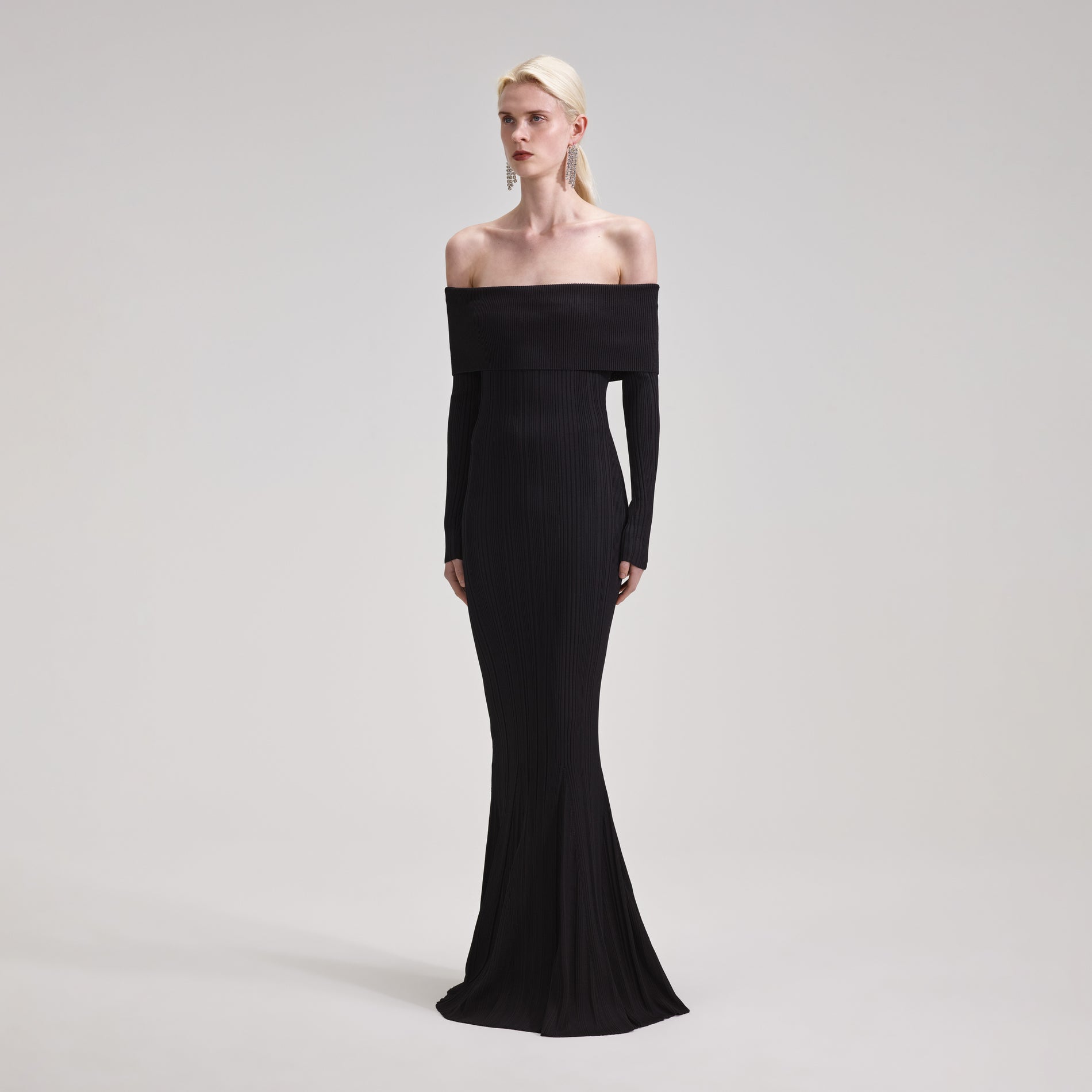 A woman wearing the Black Ribbed Knit Maxi Dress