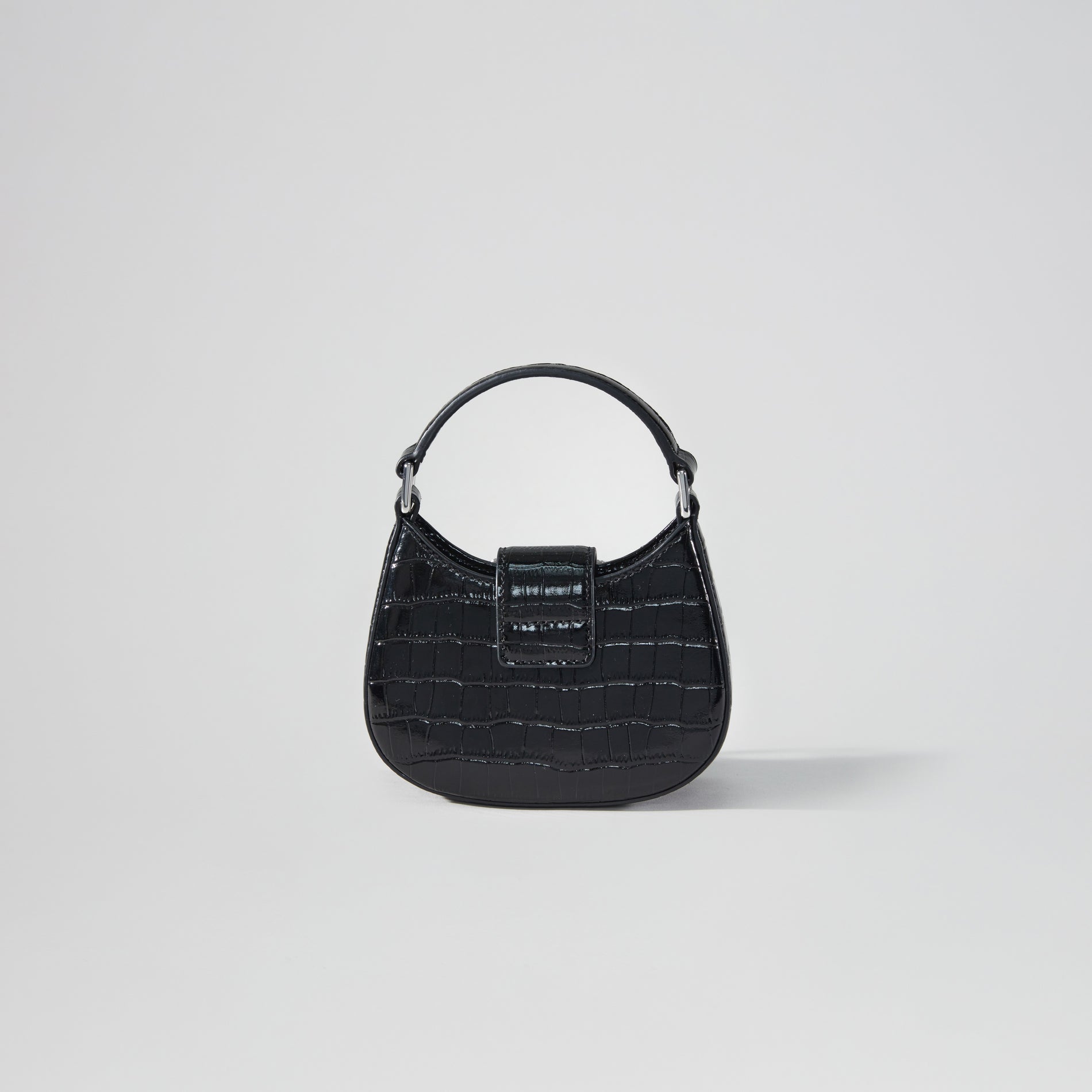 Back view of a woman wearing the Black Croc Crescent Bow Micro Bag