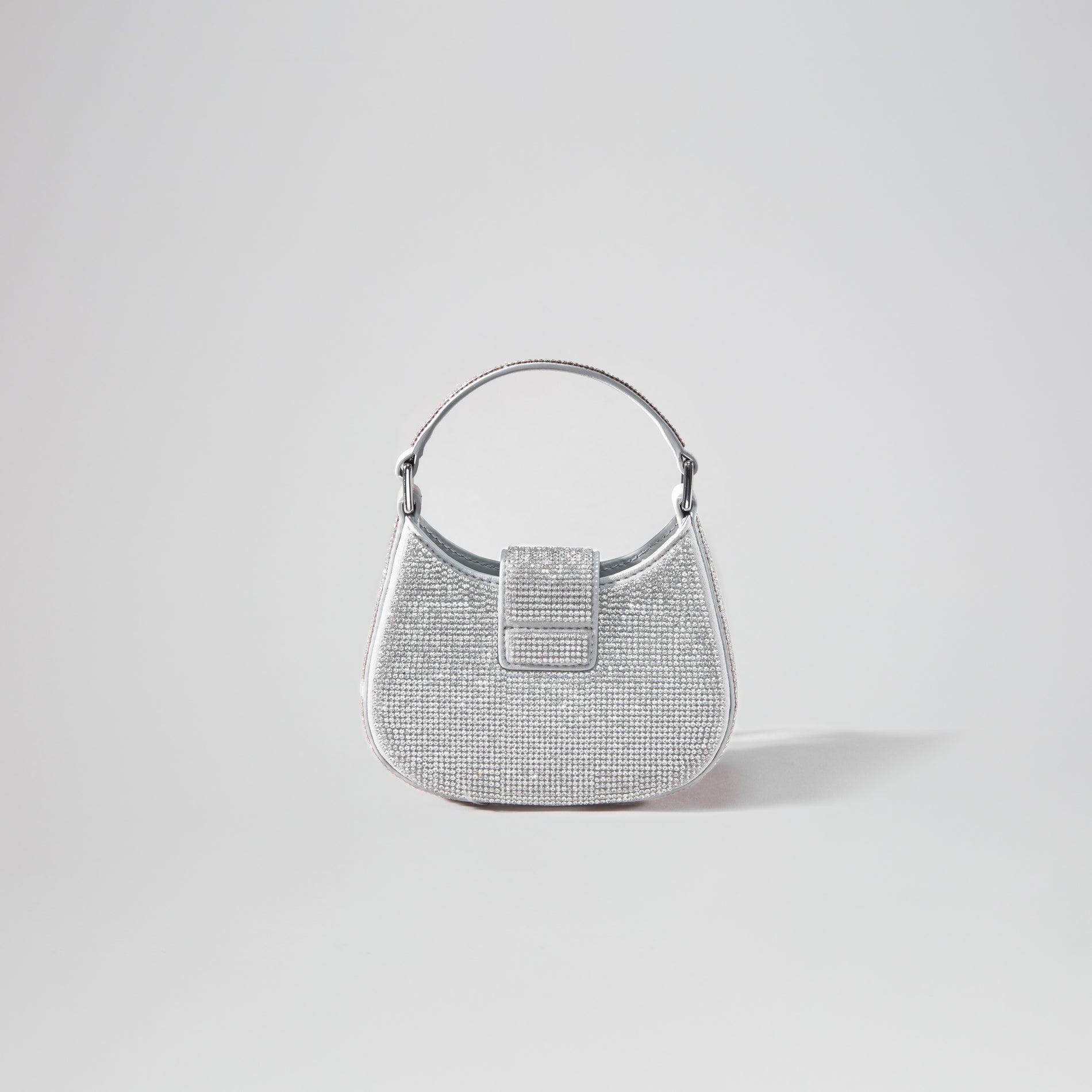 Back view of a woman wearing the Silver Rhinestone Crescent Bow Micro Bag