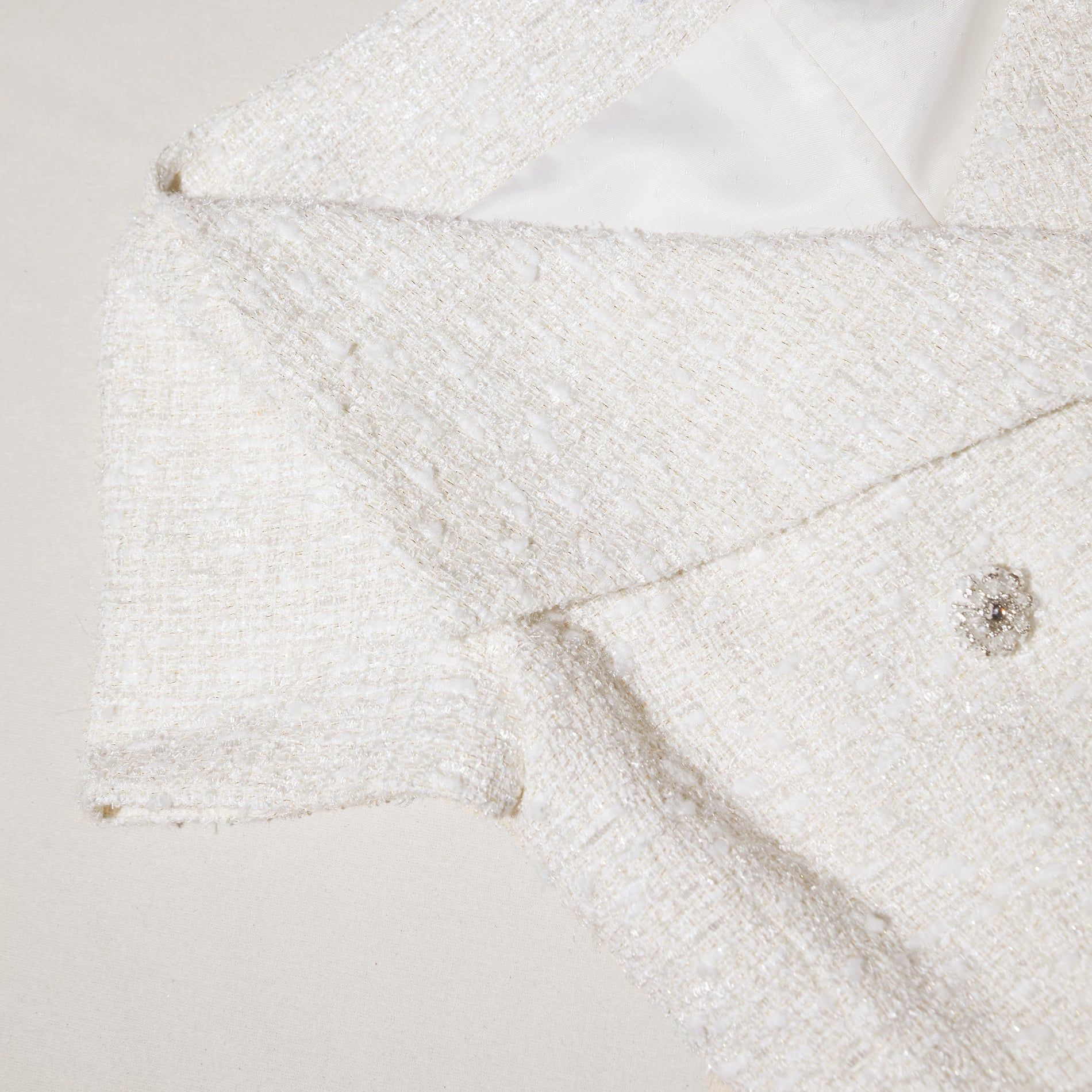 A close up of the fabric for the Cream Off Shoulder Boucle Top