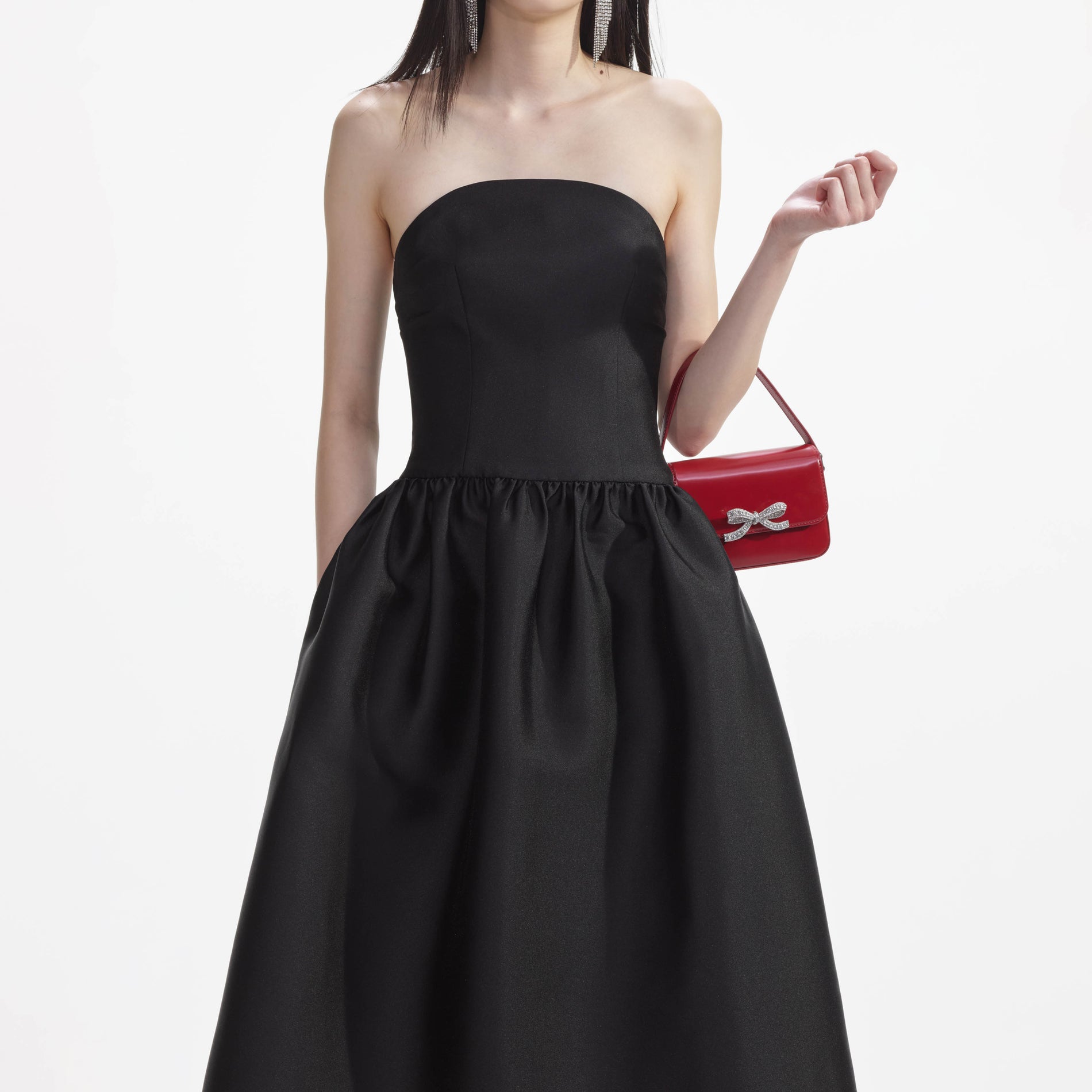 A close up of a woman wearing the Black Taffeta Midi Dress