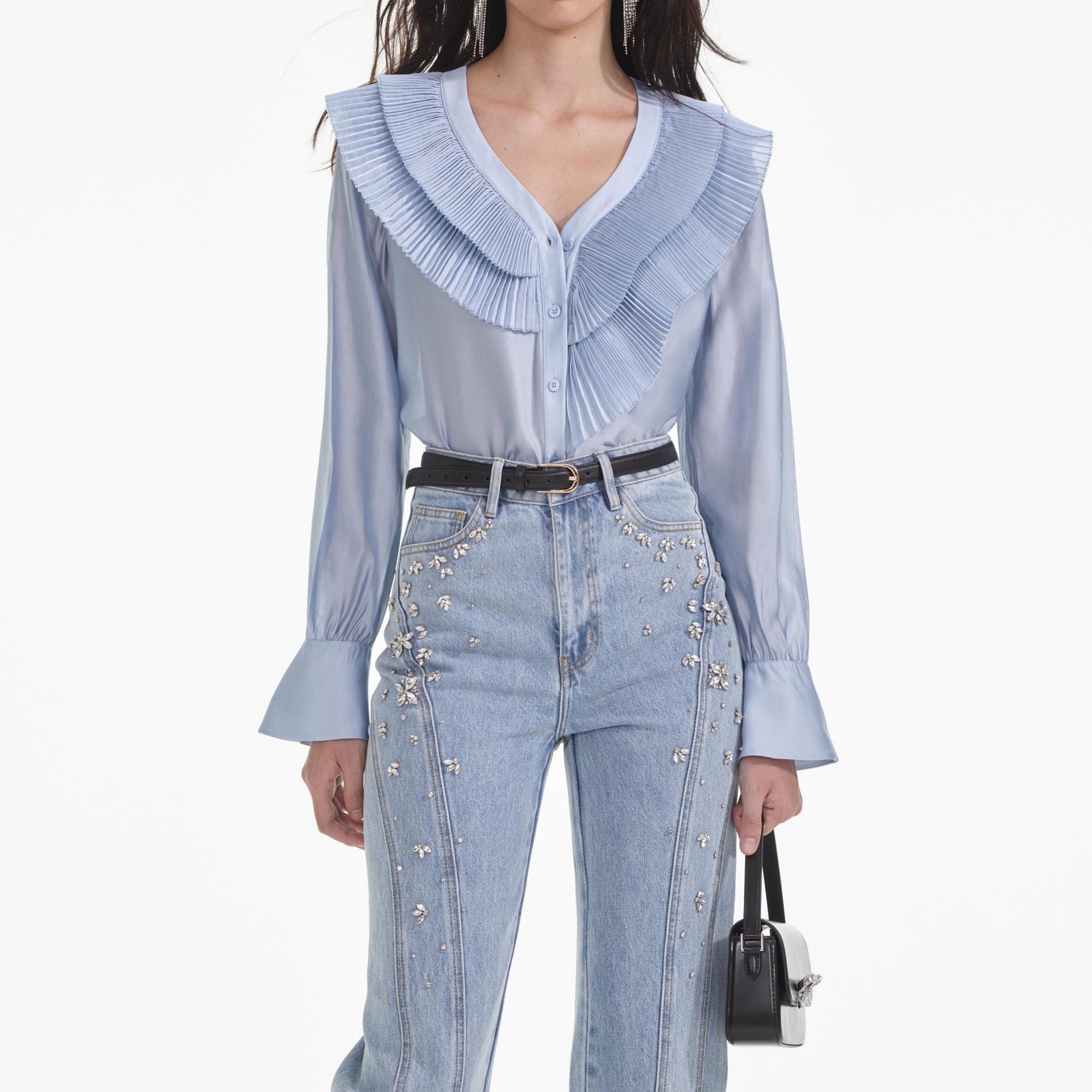 A close up of a woman wearing the Blue Satin Organza Blouse