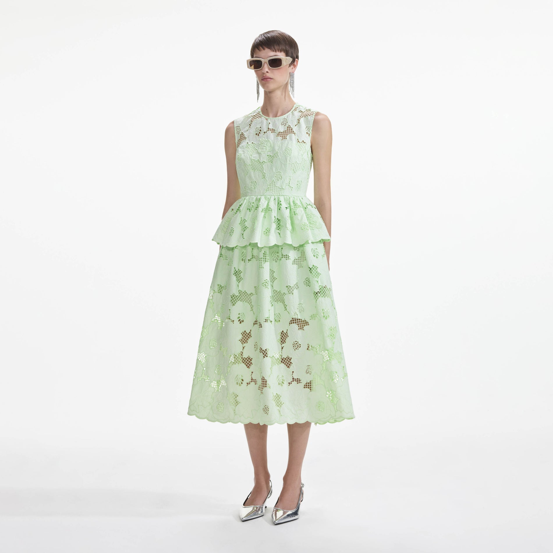 Side view of a woman wearing the Mint Cotton Lace Peplum Midi Dress