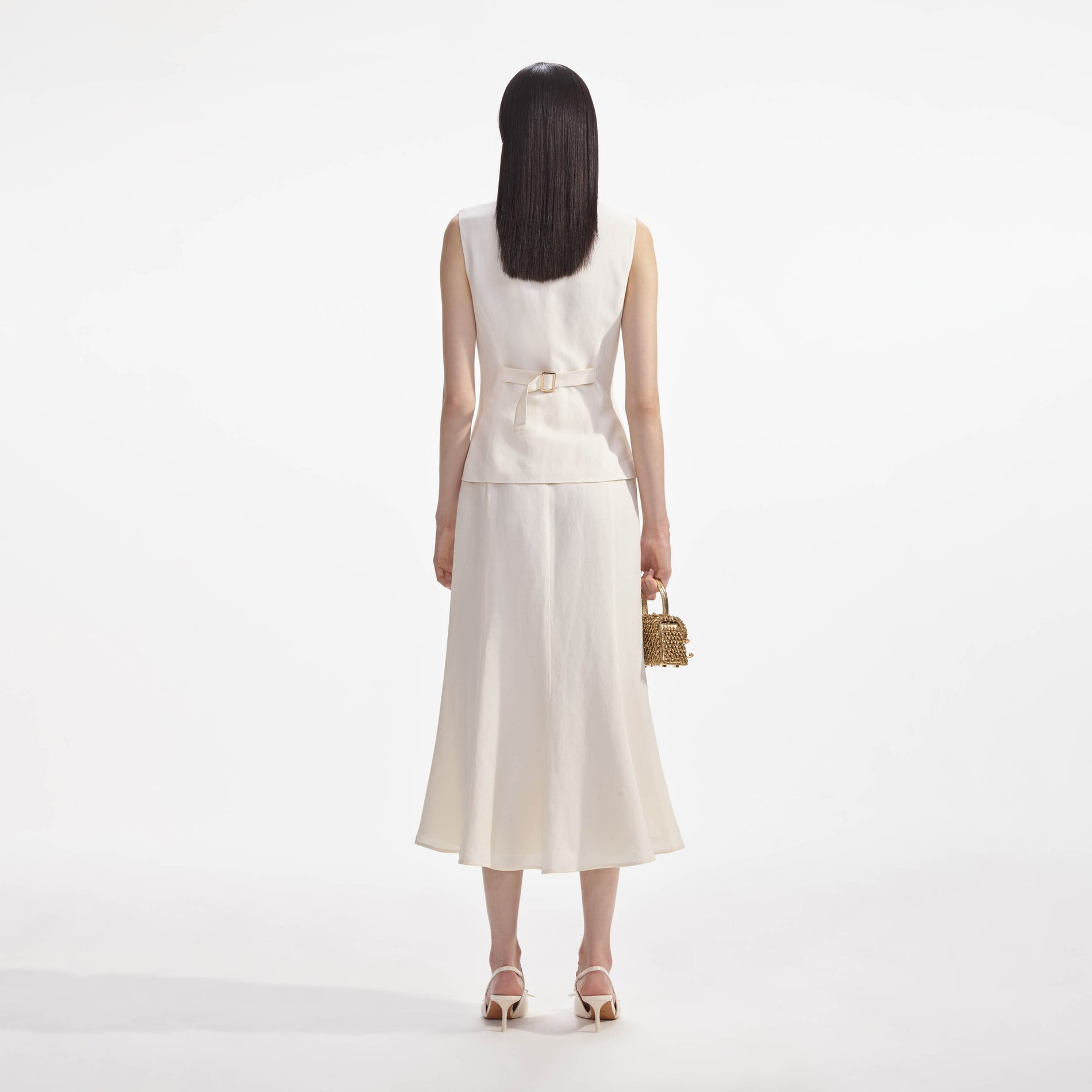 Back view of a woman wearing the Cream Linen Midi Dress