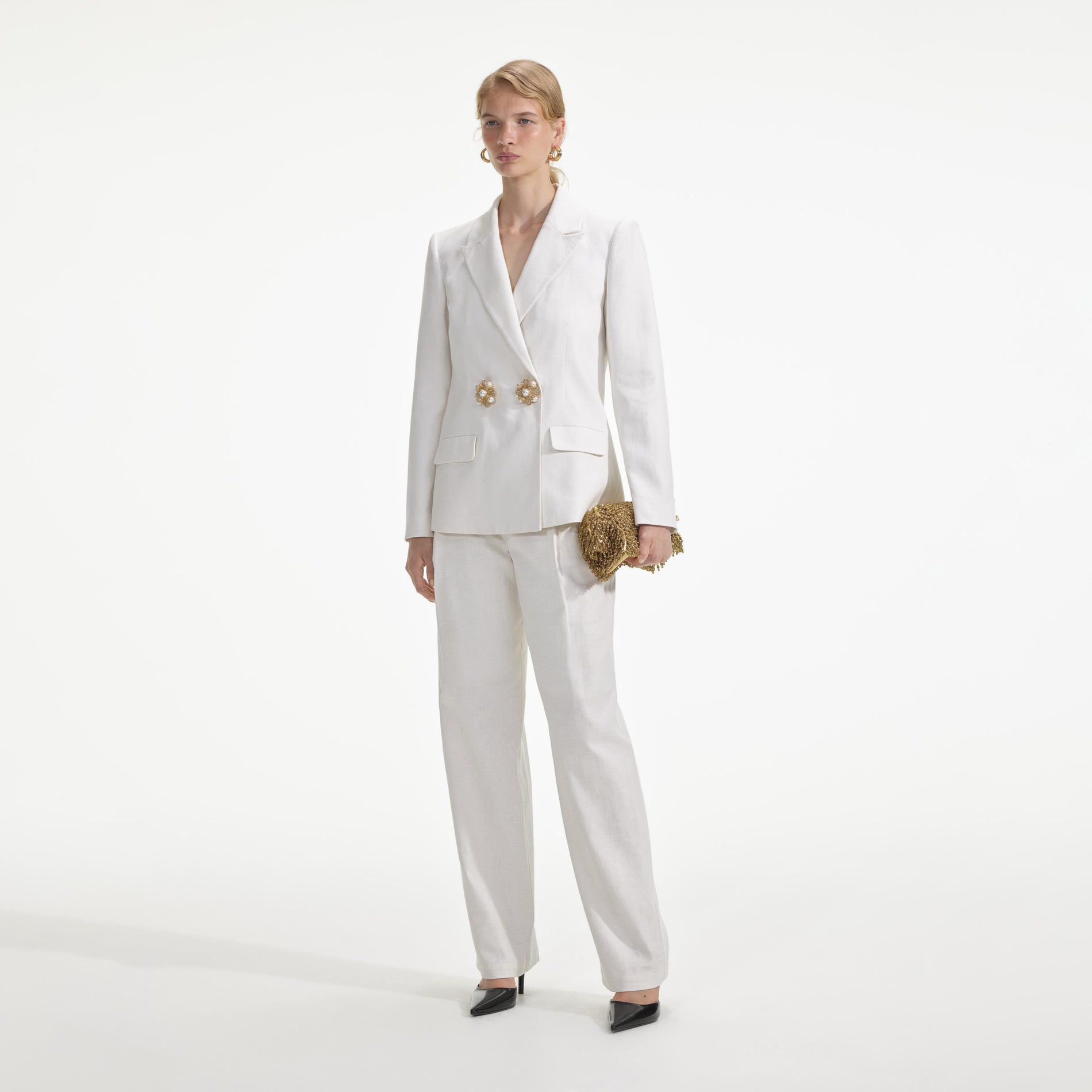 Side view of a woman wearing the White Linen Trousers