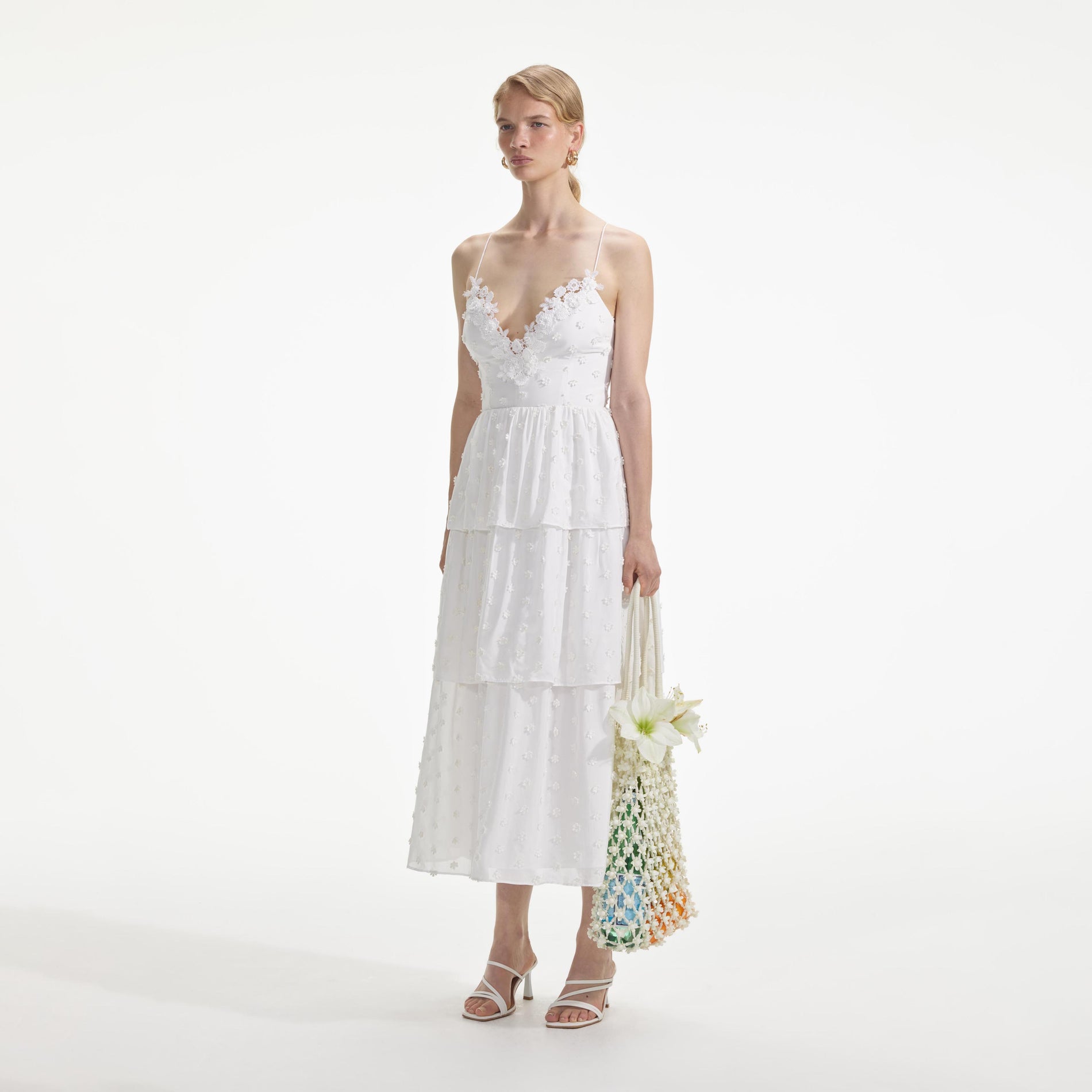 Side view of a woman wearing the White Tie Back Midi Dress
