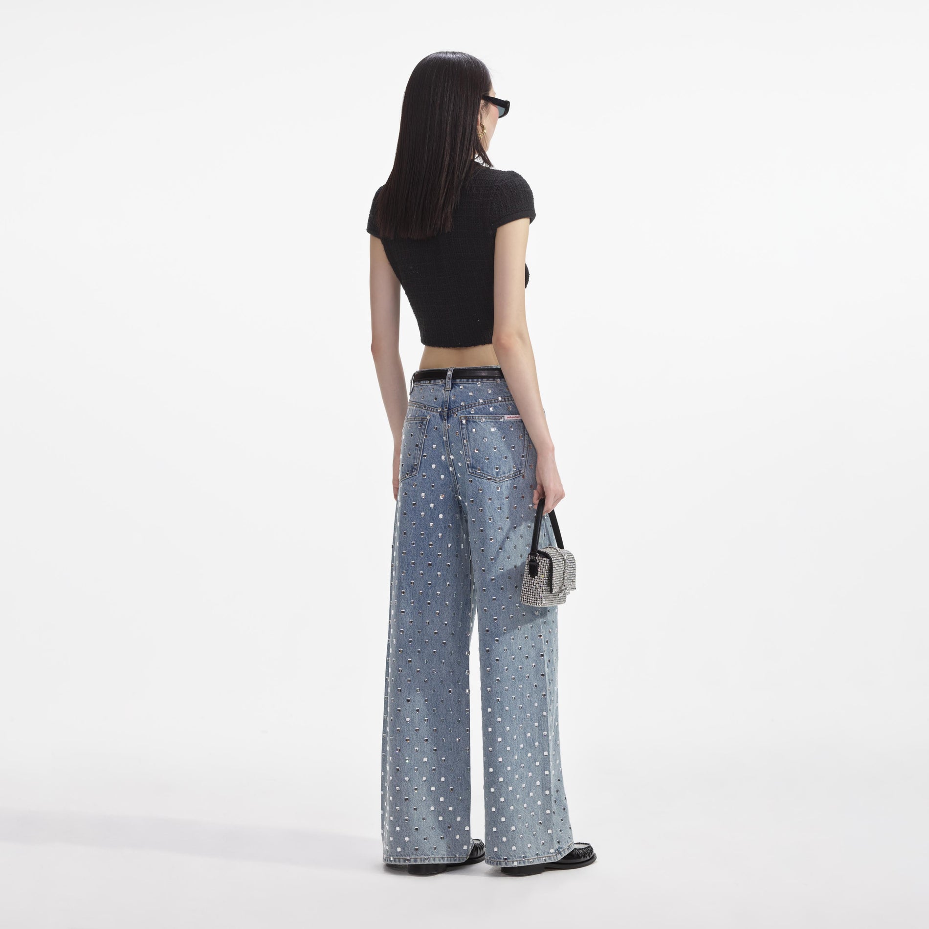 Back view of a woman wearing the Black Jewel Button Knit Top