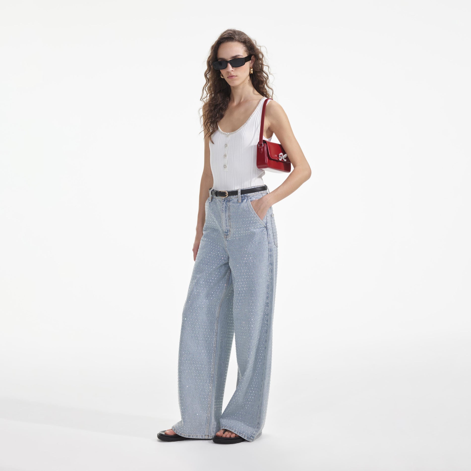 Side view of a woman wearing the Blue Rhinestone Wide Leg Jeans