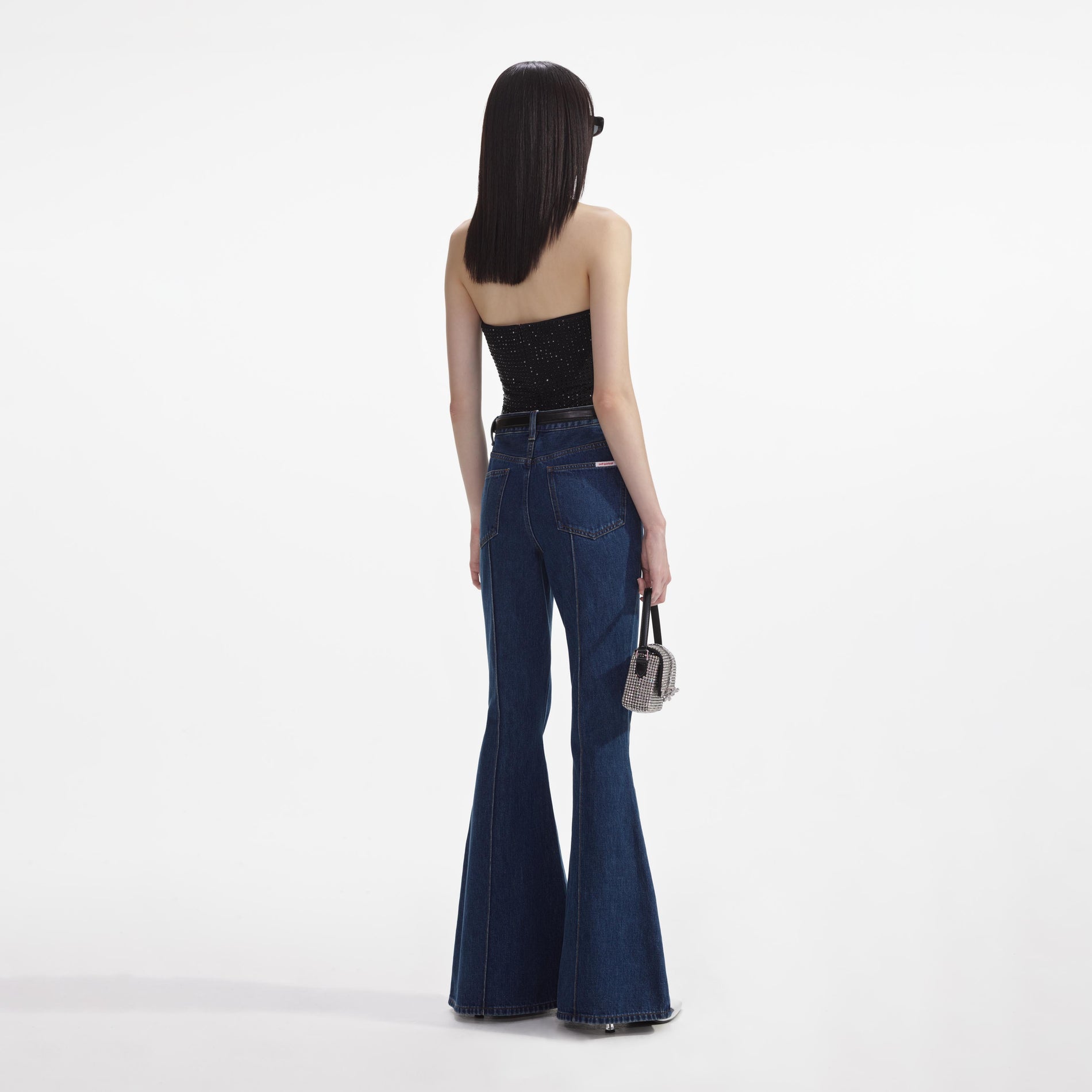 Back view of a woman wearing the Black Jersey Rhinestone Top