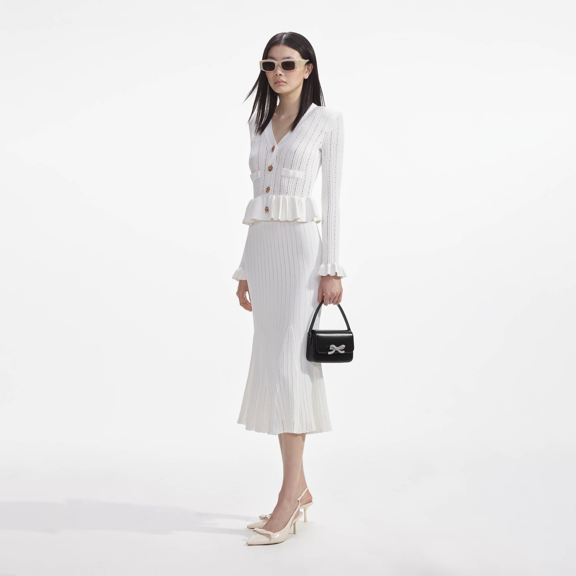 Side view of a woman wearing the White Knit Peplum Midi Dress