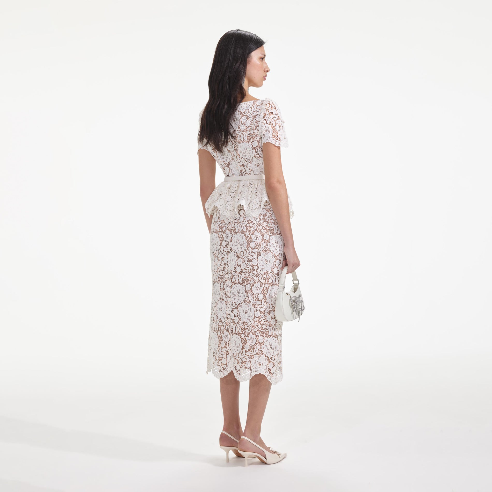 Back view of a woman wearing the Cream Lace Peplum Midi Dress