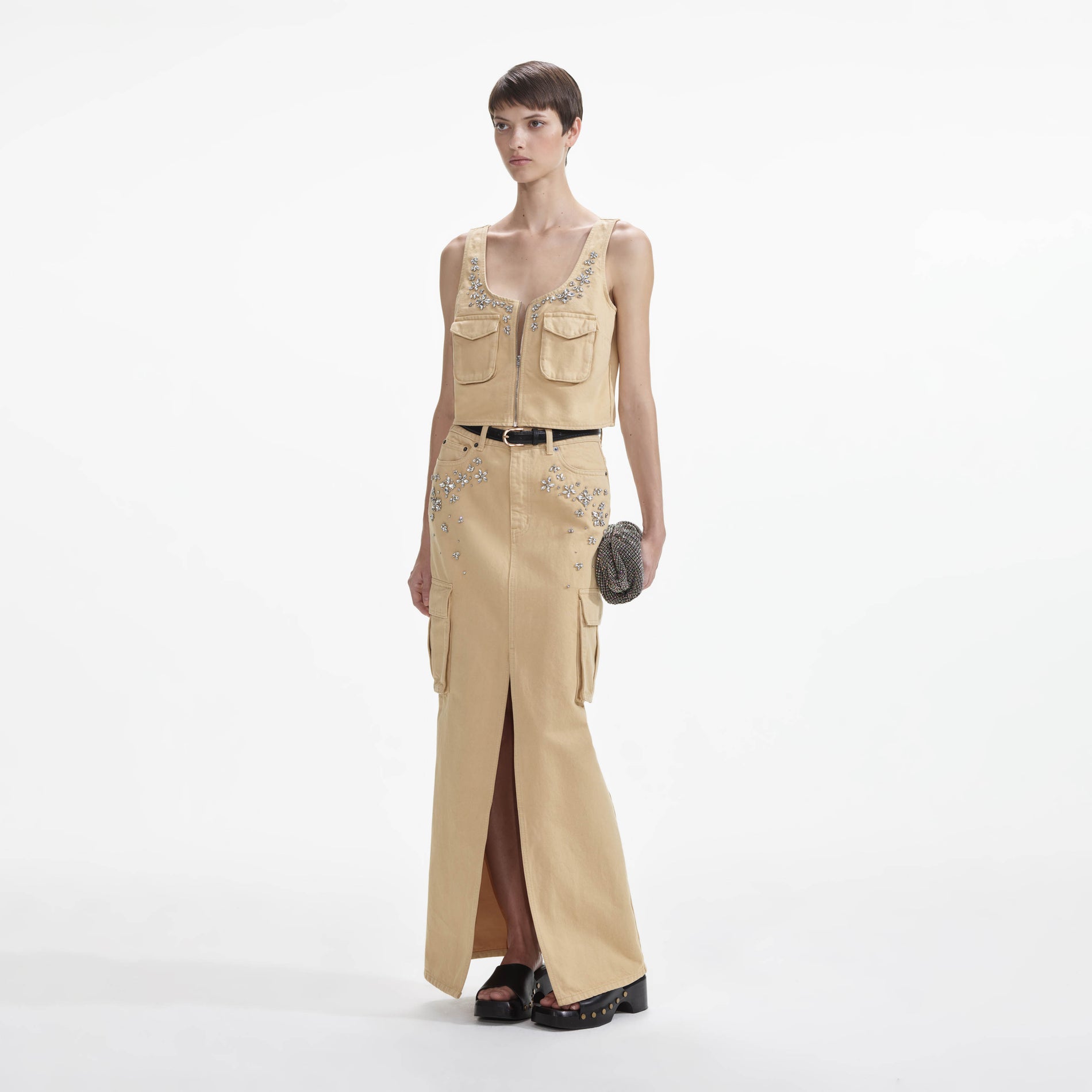 Side view of a woman wearing the Embellished Denim Cargo Maxi Skirt