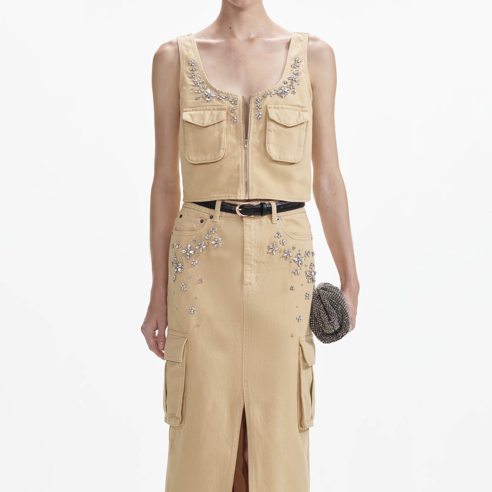 A close up of a woman wearing the Embellished Denim Cargo Maxi Skirt