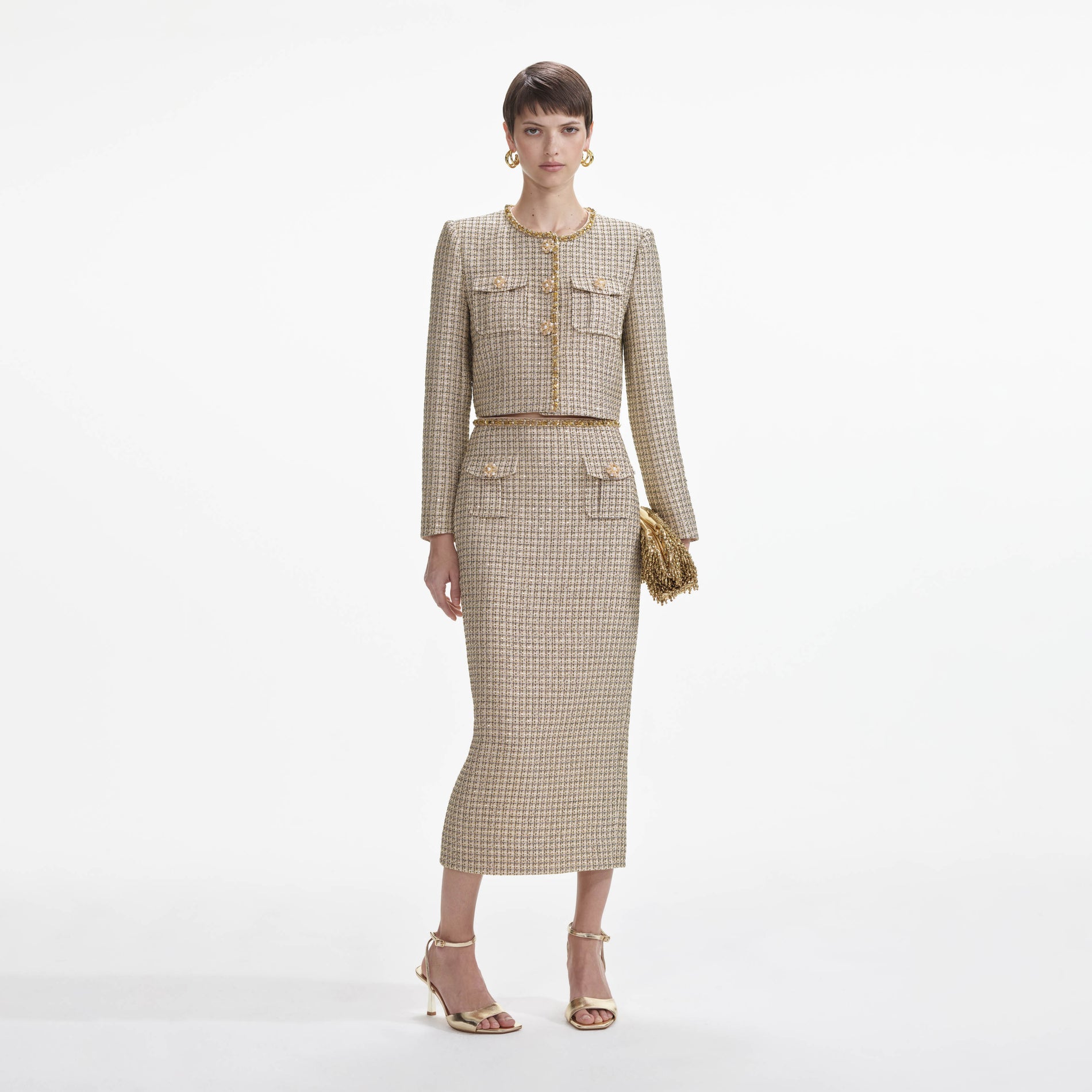 Front view of a woman wearing the Gold Boucle Midi Skirt