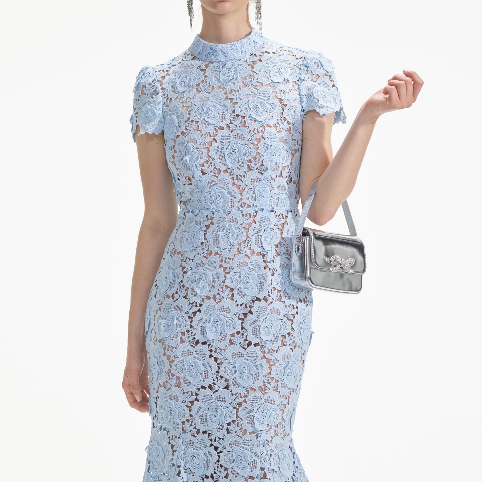 A close up of a woman wearing the Blue Flower Lace Midi Dress