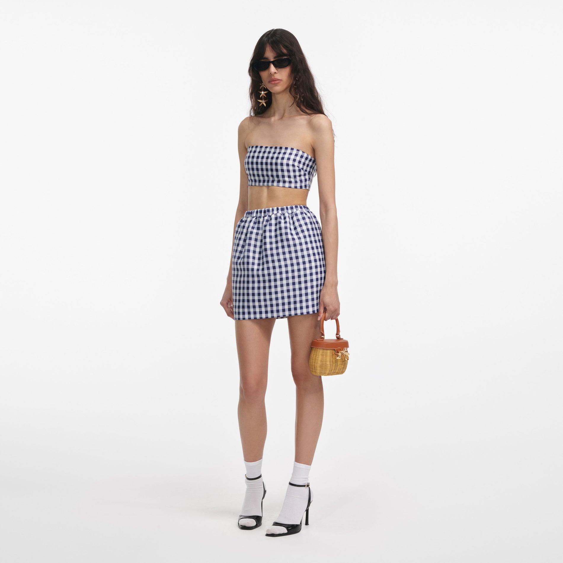 Side view of a woman wearing the Navy Gingham Taffeta Mini Skirt