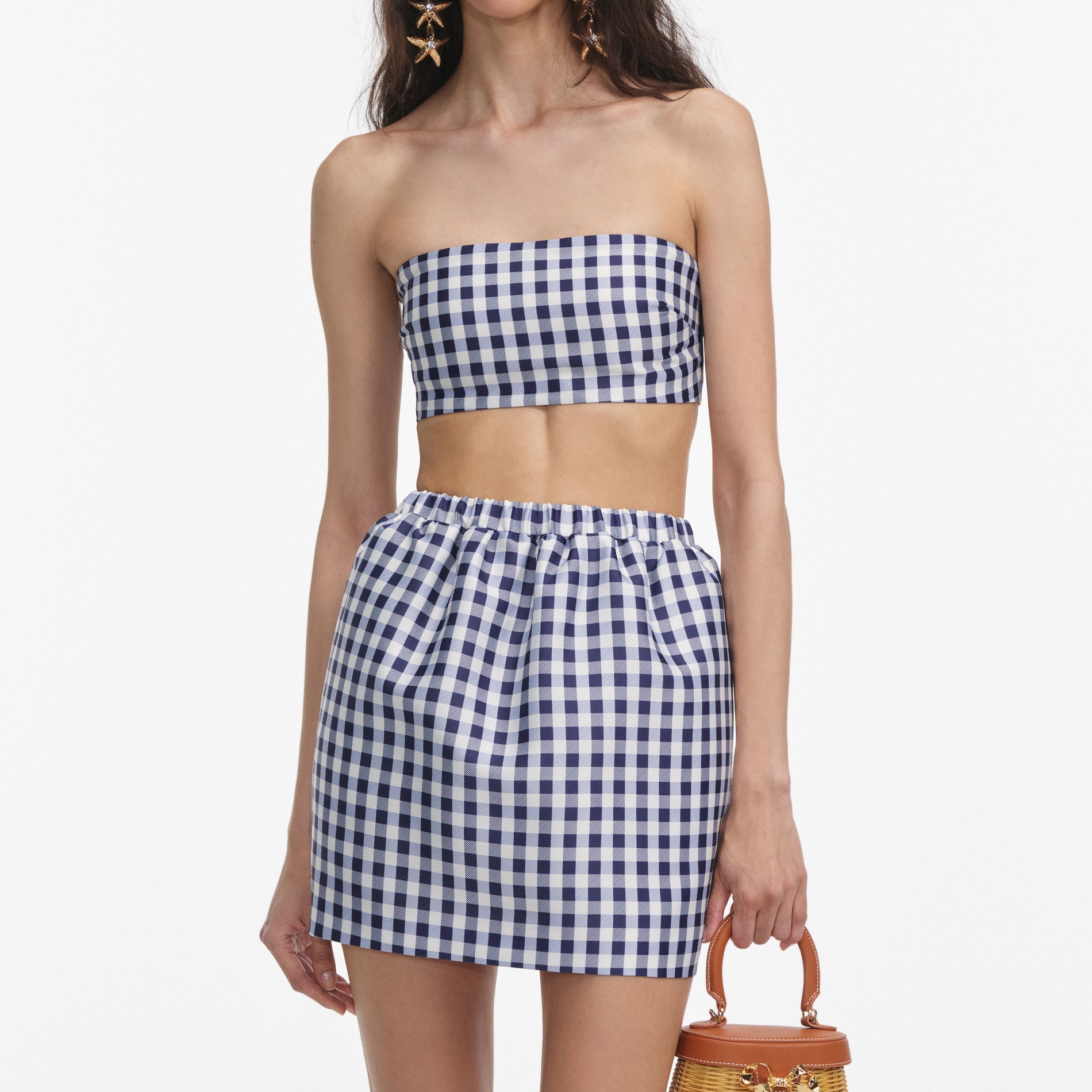 A close up of a woman wearing the Navy Gingham Taffeta Mini Skirt