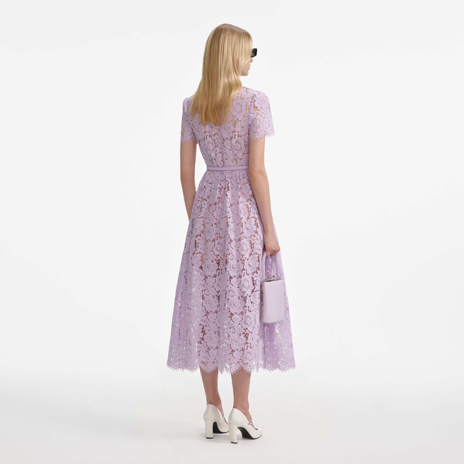 Back view of a woman wearing the Lilac Lace Button Front Midi Dress